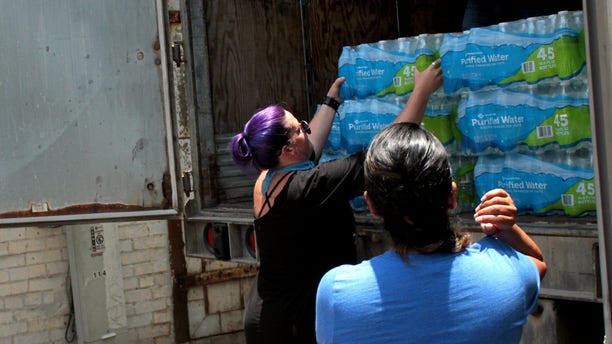 Destiny Herndon-De La Rosa, New Wave Feminists, unloads water at respite center in McAllen, Texas.