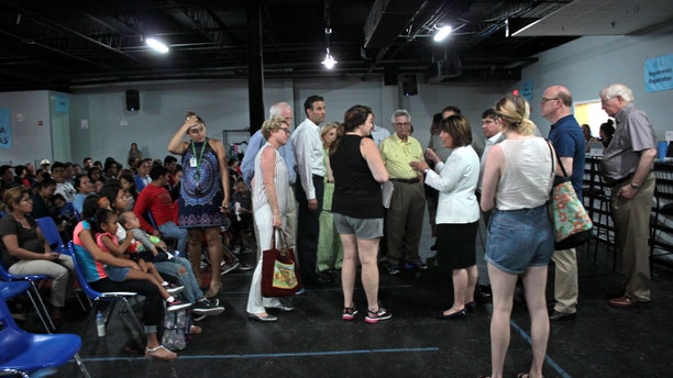 Abby Johnson (in shorts and black top) speaking with Democratic members of Congress at the respite center in McAllen, Texas. 
