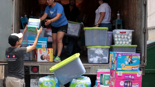 Volunteers unloading the truck of supplies at respite center in McAllen, Texas.