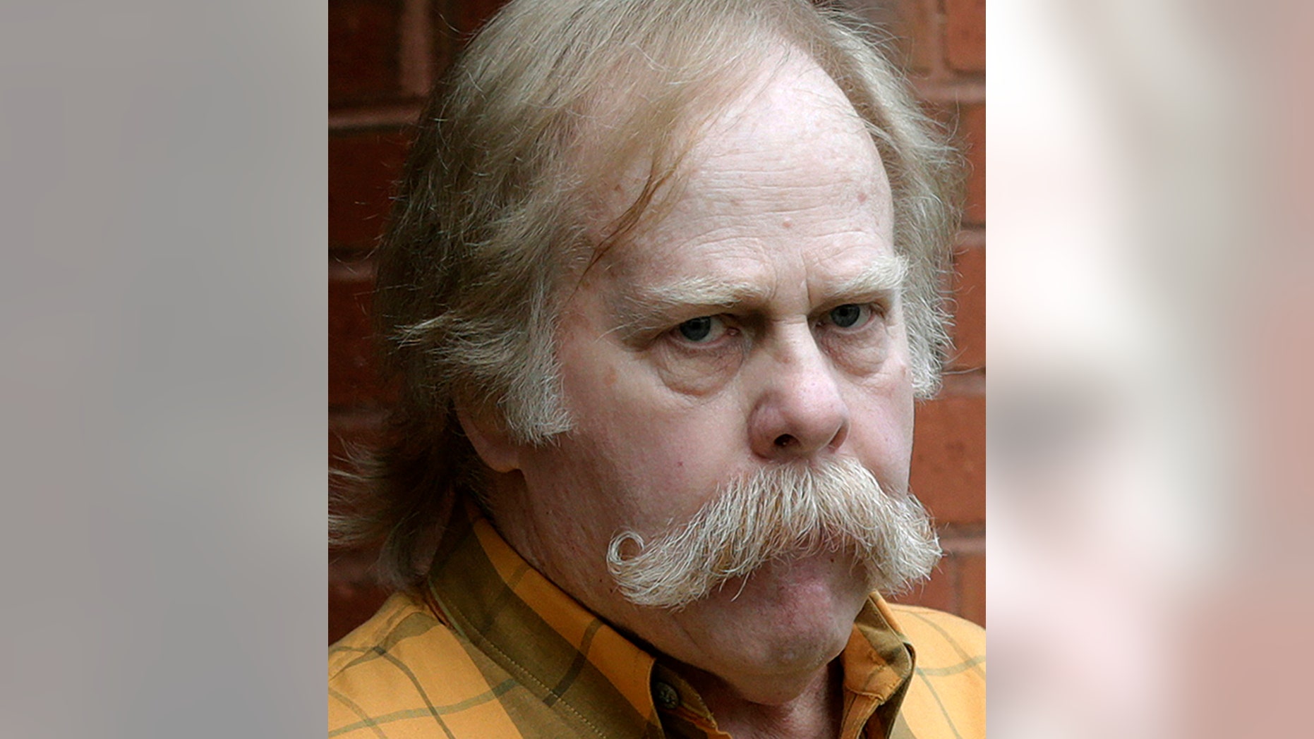 FILE -- In this June 10, 2013 file photo, University of Alabama fan Harvey Updyke departs the Lee County Justice Center in Opelika, Ala., after pleading guilty earlier to poisoning landmark oak trees at Auburn University. Updyke, a retired Texas state trooper, was ordered to pay about $800,000 in restitution, and he is due in court on Oct. 30, 2019, to explain why the money isn't being paid. (AP Photo/Dave Martin, File)