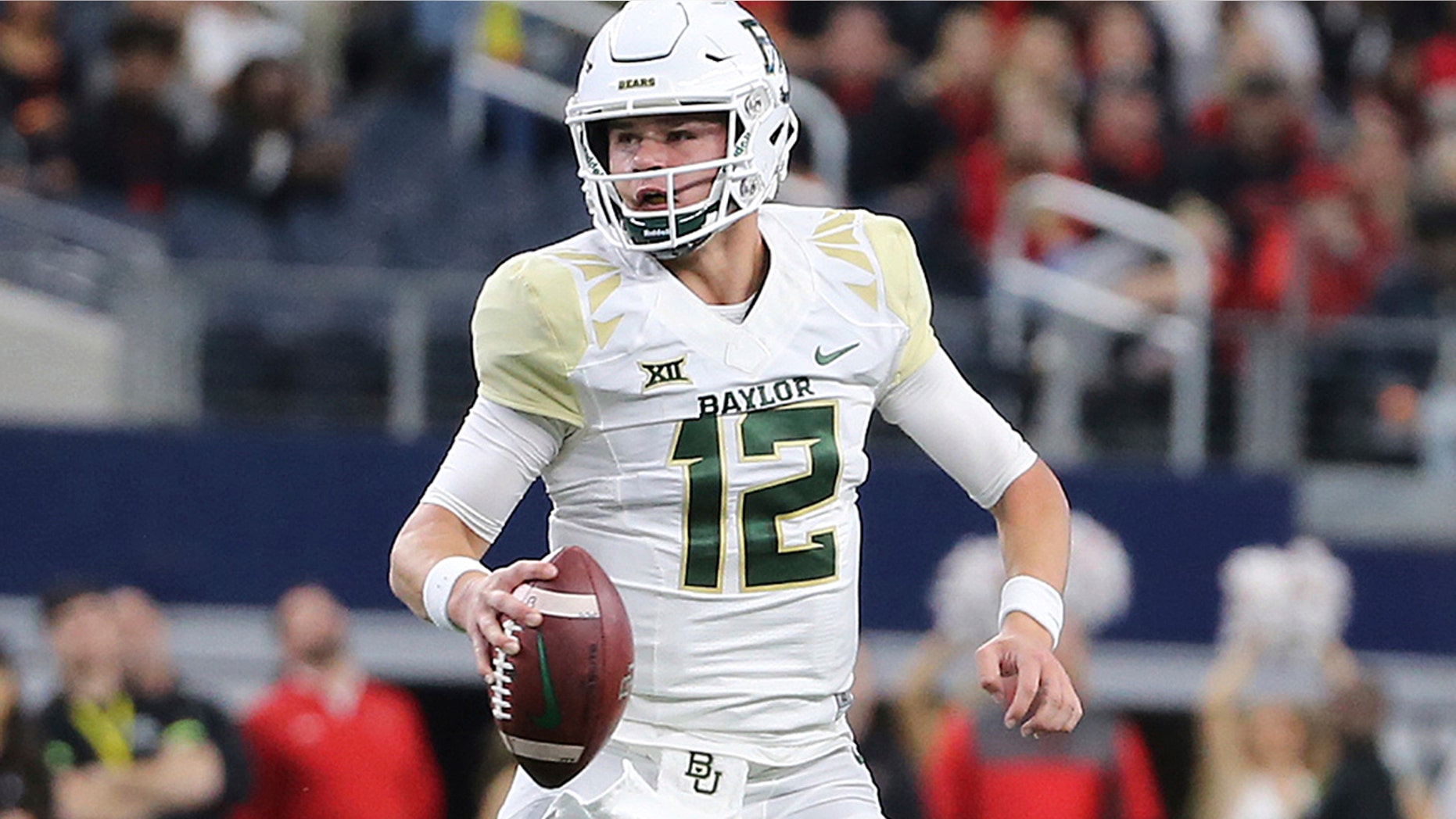 FILE - In this Nov. 24, 2018, file photo, Baylor quarterback Charlie Brewer scrambles out of the pocket before throwing a pass in the first half of an NCAA college football game against Texas Tech in Arlington, Texas. (Jerry Larson/Waco Tribune-Herald via AP, file)