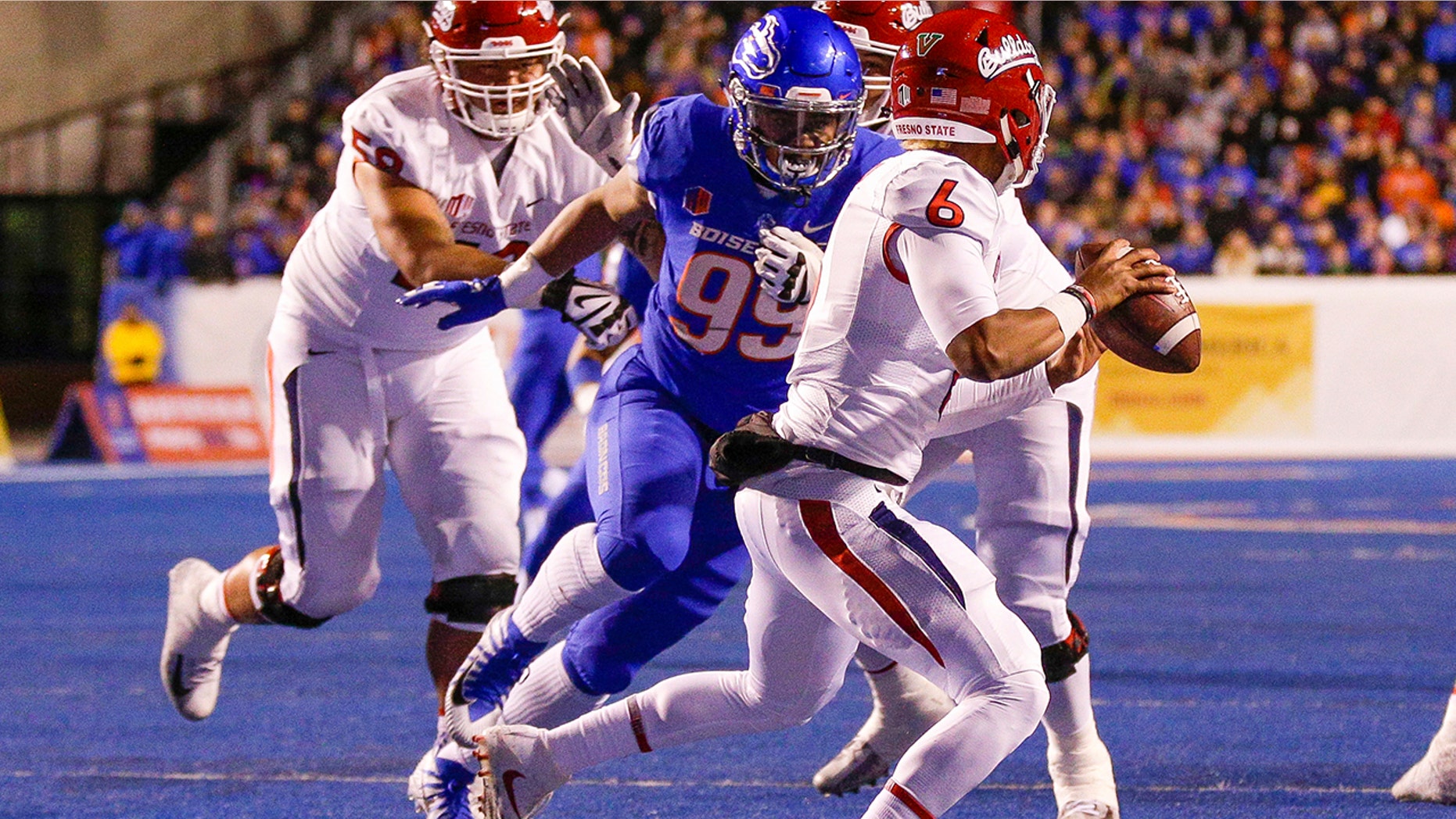 FILE - In this Nov. 9, 2018, file photo, Boise State's Curtis Weaver (99) closes in on Fresno State quarterback Marcus McMaryion (6) in the first half of an NCAA college football game in Boise, Idaho. The Broncos have the preseason MWC defensive player of the year in Curtis Weaver, who collected 9 ½ sacks last season. (AP Photo/Steve Conner, File)