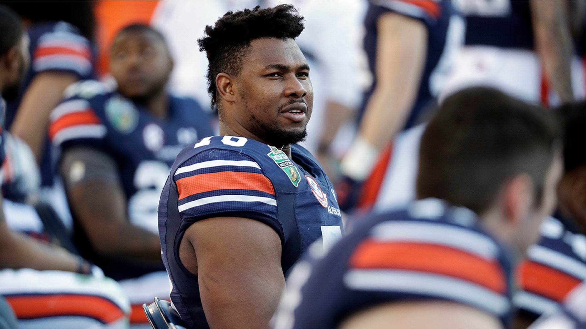FILE - In this Dec. 28, 2018, file photo, Auburn offensive lineman Prince Tega Wanogho (76) watches from the sideline in the second half of the Music City Bowl NCAA college football game against Purdue, in Nashville, Tenn. Prince Tega Wanogho came to Alabama from Nigeria wanting to be the next LeBron James. He became Auburn’s left tackle instead. (AP Photo/Mark Humphrey, File)