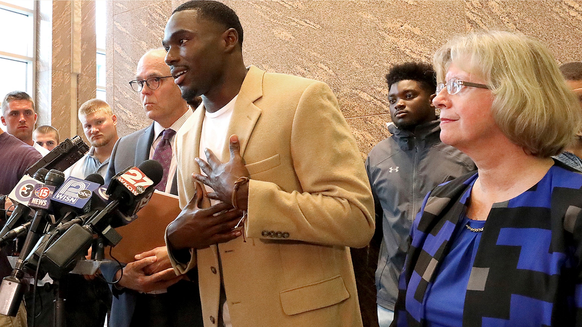 Former Wisconsin Badger football player Quintez Cephus speaks during a press conference to reiterate his request for reinstatement to the university in Madison, Wis. Monday, Aug. 12, 2019. The former wide receiver was acquitted earlier this month of sexual assault charges stemming from a campus incident in his apartment. He was expelled from the university in March after the university's own internal investigation. He is pictured with his attorneys, Stephen Meyer and Kathleen Stilling, as well as a group of current team members were on hand to show support for Cephus at the event. (John Hart/Wisconsin State Journal via AP)