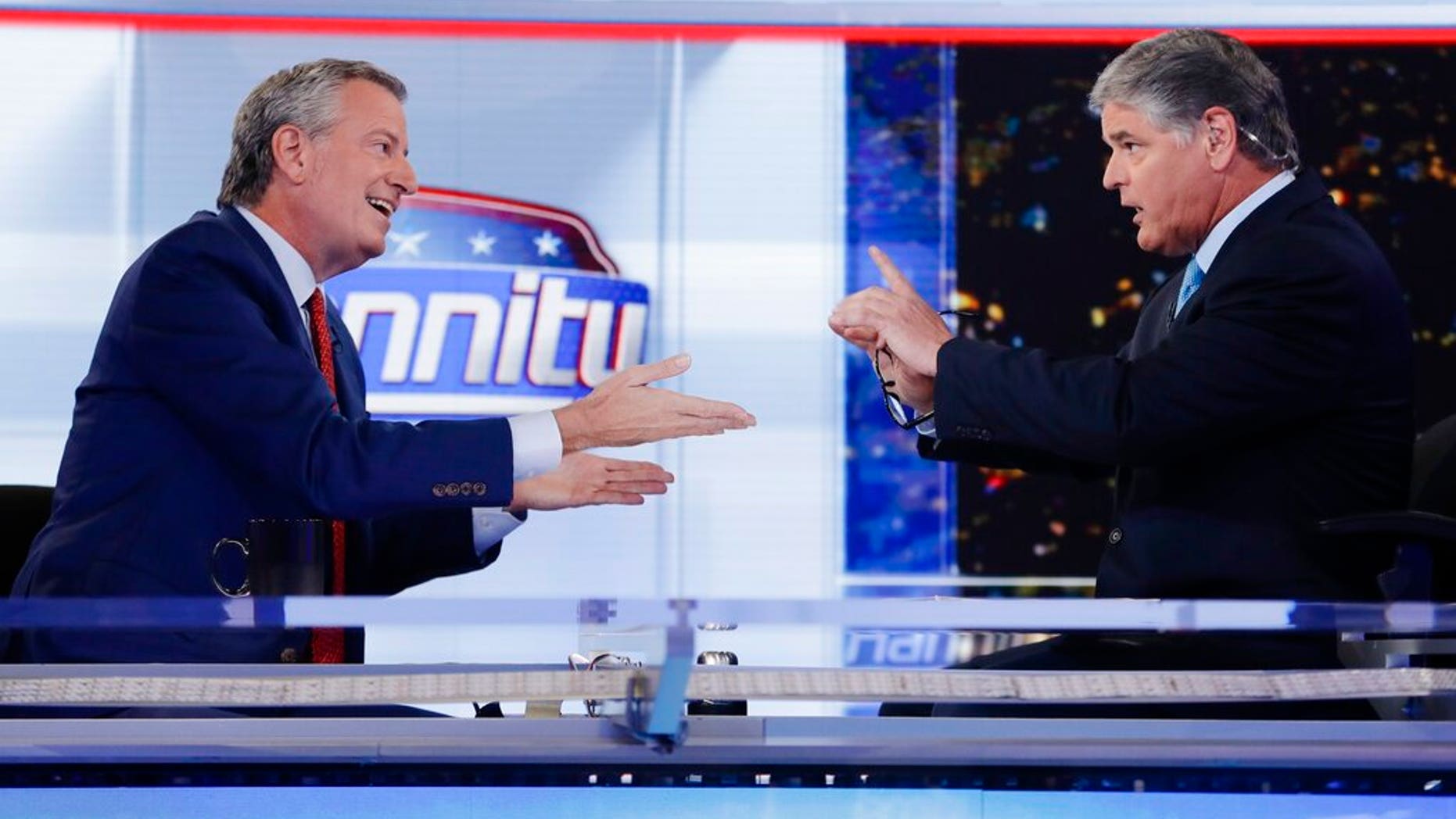 Fox News host Sean Hannity, right, interviews Democratic presidential candidate and New York Mayor Bill de Blasio during a taping of his show, "Hannity." (AP Photo/Frank Franklin II)