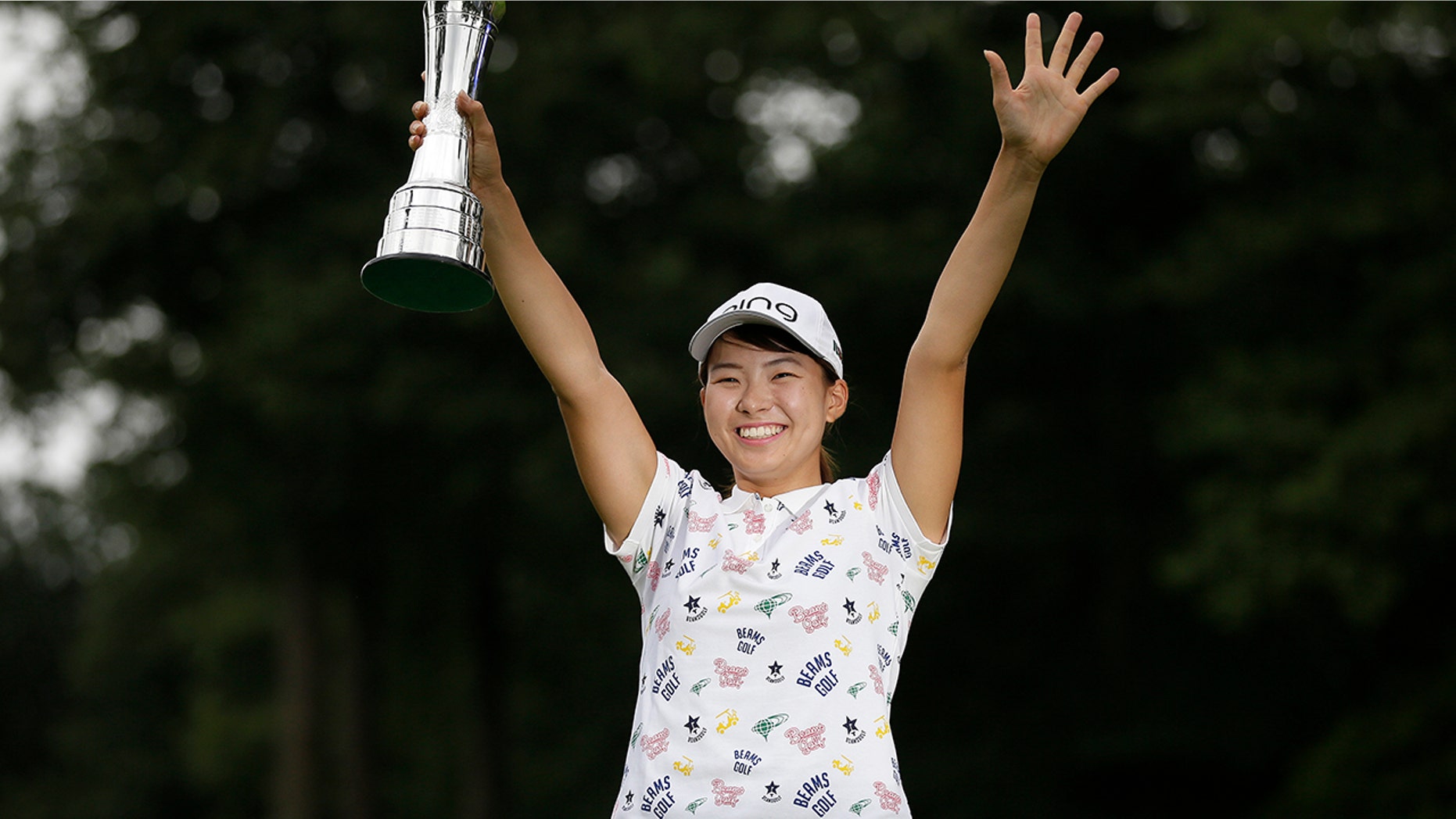 Japan's Hinako Shibuno reacts as she holds the trophy as she celebrates after winning the Women's British Open golf championship at Woburn Gold Club near near Milton Keynes, England, Sunday, Aug. 4, 2019. (AP Photo/Tim Ireland)
