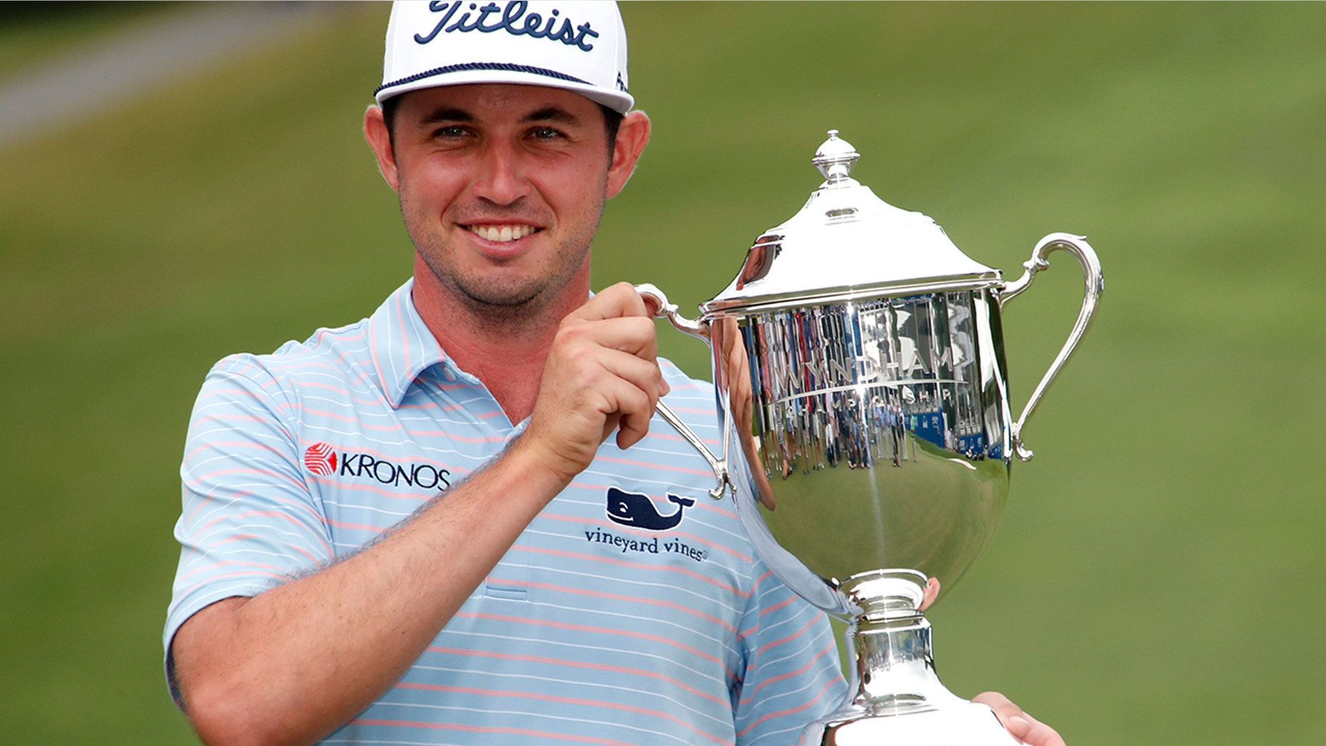 J. T. Poston holds the trophy after he won the Wyndham Championship golf tournament at Sedgefield Country Club in Greensboro, N.C., Sunday, Aug. 4, 2019. (AP Photo/Chris Seward)