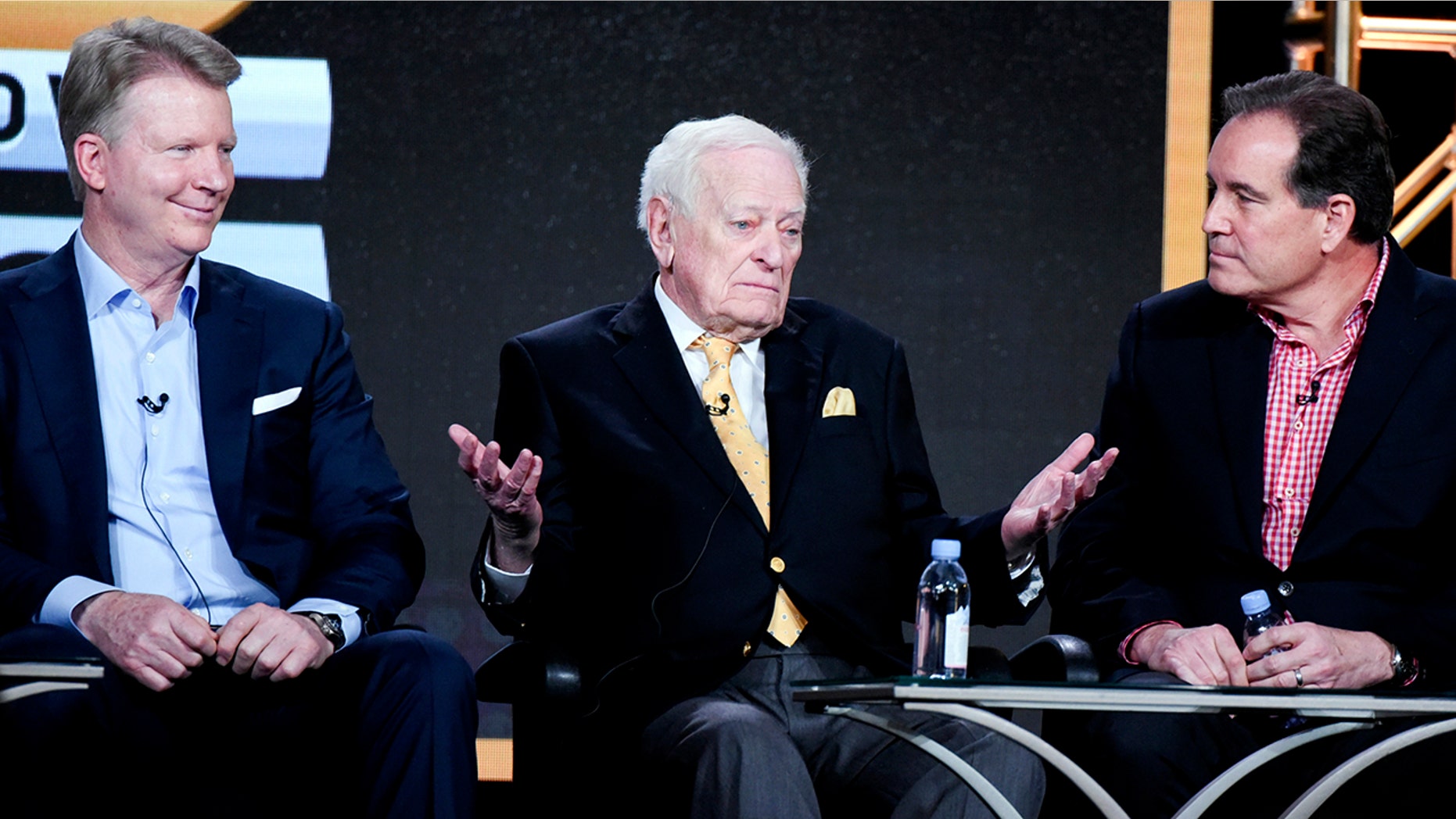 FILE - In this January 12, 2016 file photo, left to right, sports stunts Phil Sims, Jack Whitaker and Jim Nantz participate in