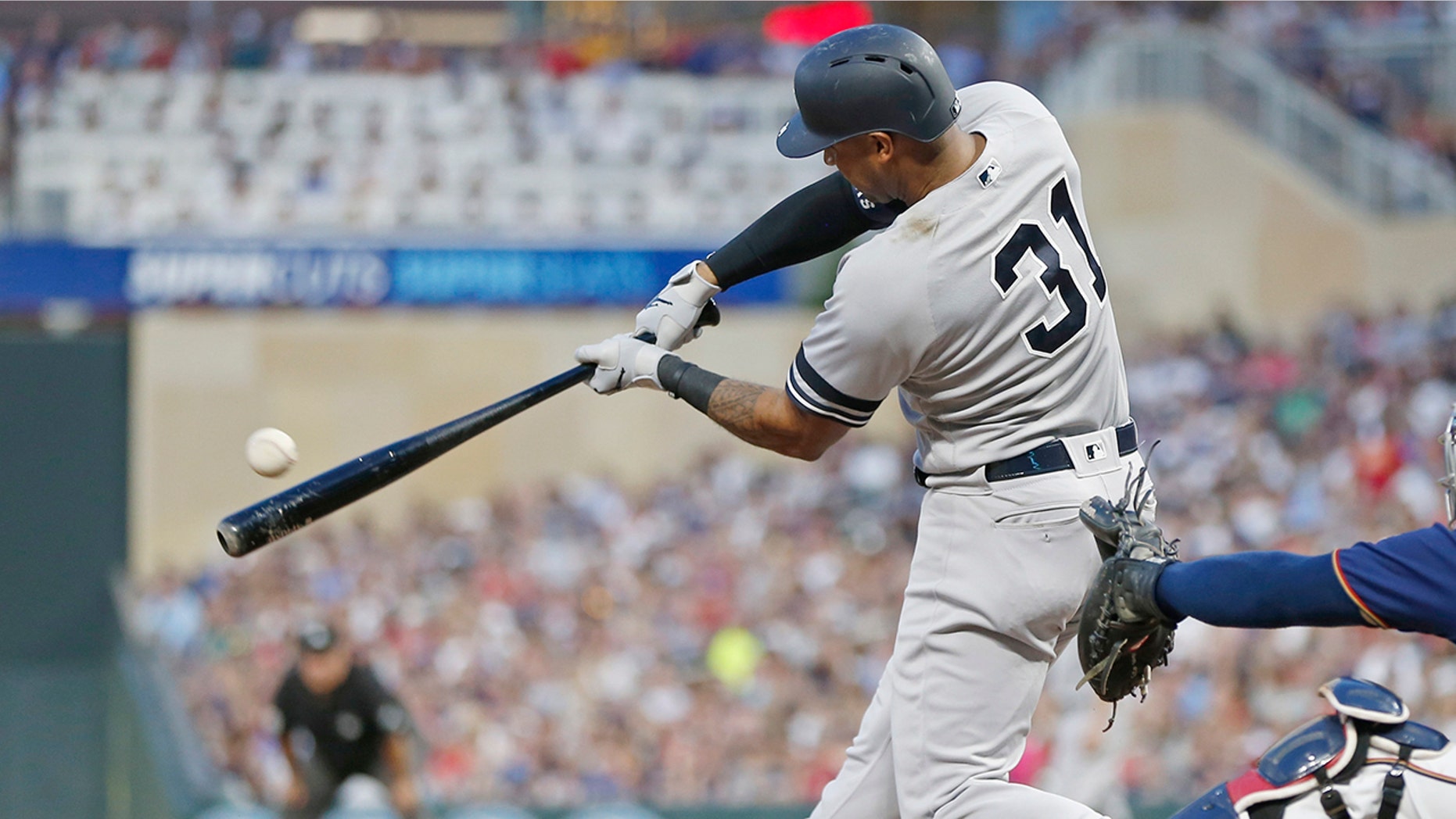 New York Yankees' Aaron Hicks hits an RBI single off Minnesota Twins pitcher Jake Odorizzi in the fourth inning of a baseball game Wednesday, July 24, 2019, in Minneapolis. (AP Photo/Jim Mone)