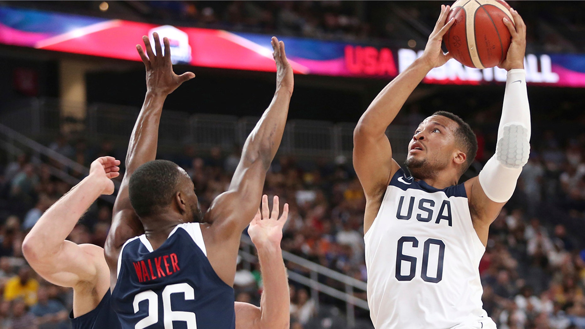 Team White guard Jalen Brunson (60) goes up for a shot under pressure from Team Blue guard Kemba Walker (26) during the first half of the U.S. men's basketball team's scrimmage in Las Vegas, Friday, Aug. 9, 2019. (Erik Verduzco/Las Vegas Review-Journal via AP)