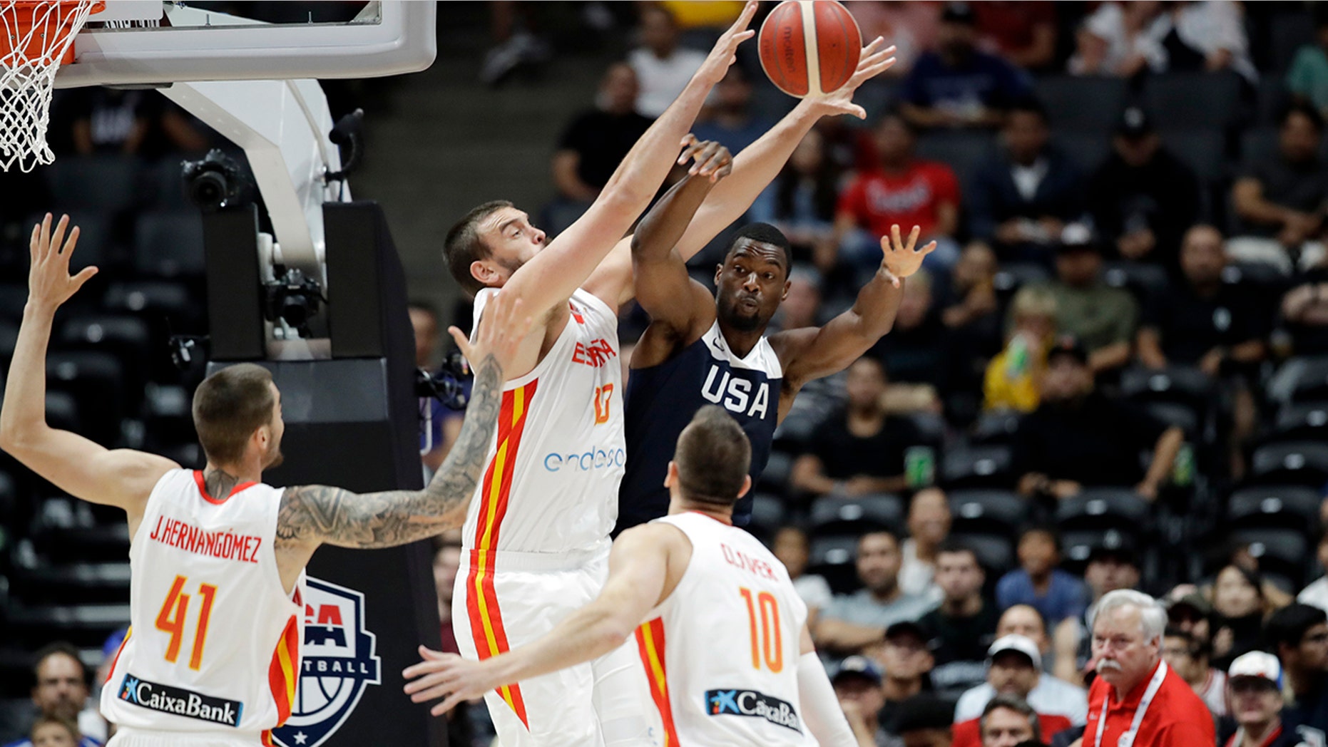 United States' Harrison Barnes, center right, is defended by Spain's Marc Gasol, center left, during the first half of an exhibition basketball game Friday, Aug. 16, 2019, in Anaheim, Calif. (AP Photo/Marcio Jose Sanchez)