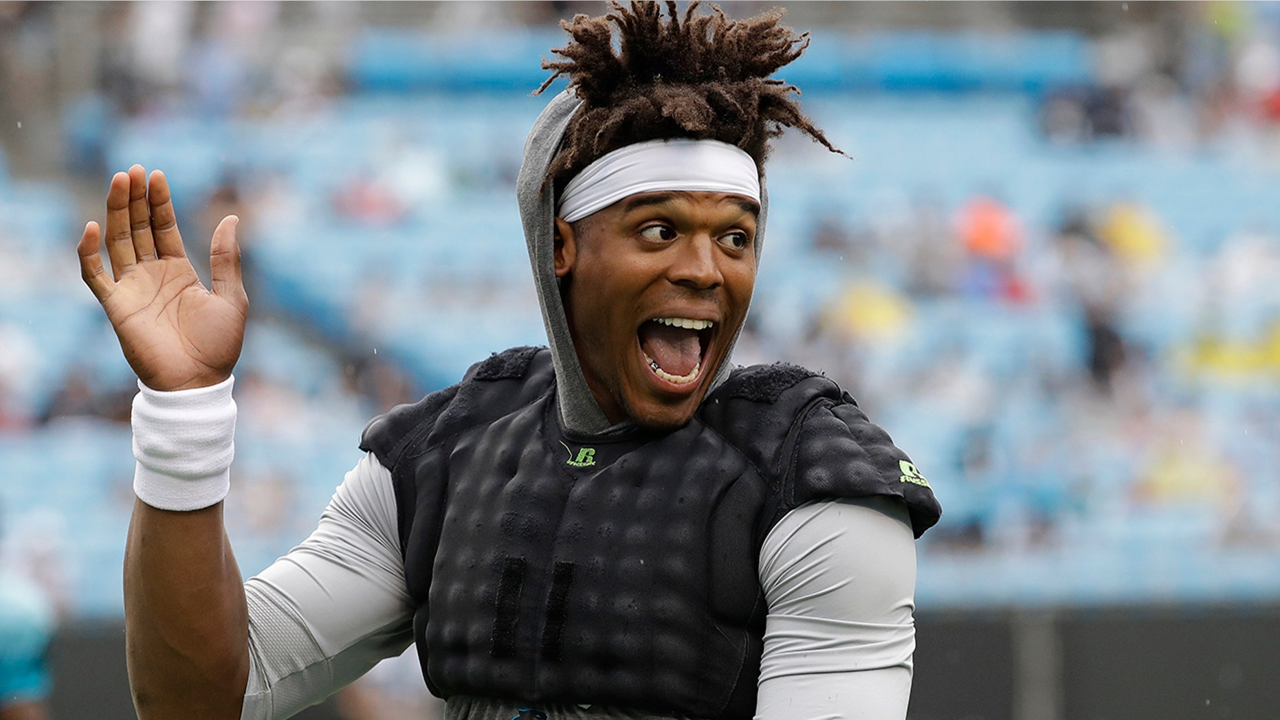 Carolina Panthers quarterback Cam Newton waves to the crowd during a Fan Fest practice at the NFL football team's training camp in Charlotte, N.C., Friday, Aug. 2, 2019. (AP Photo/Chuck Burton)