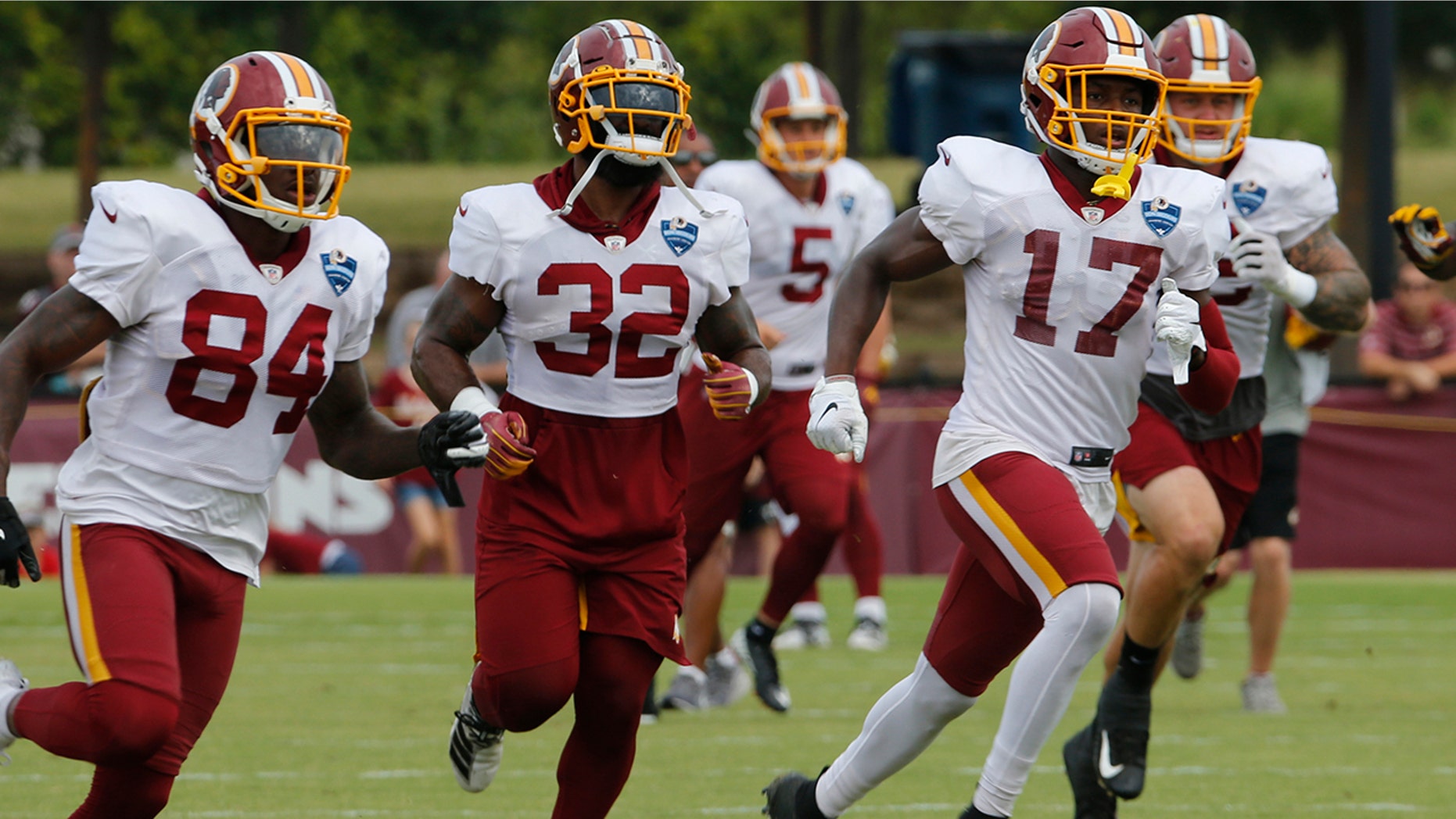 FILE - In this Aug. 5, 2019, file photo, Washington Redskins wide receiver Terry McLaurin (17) runs drills with teammates Samaje Perine (32) and Darlin Kidsy Jr., (84) during the Washington Redskins NFL football training camp in Richmond, Va. (AP Photo/Steve Helber, File)