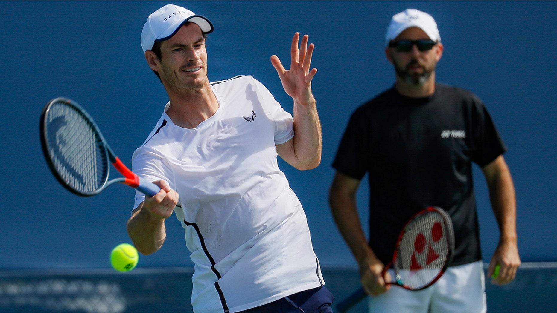 Andy Murray, left, of Britain, practices as his coach Jamie Delgado, right, at the Western & Southern Open tennis tournament, Sunday, Sunday, Aug. 11, 2019, in Mason, Ohio. (AP Photo/John Minchillo)