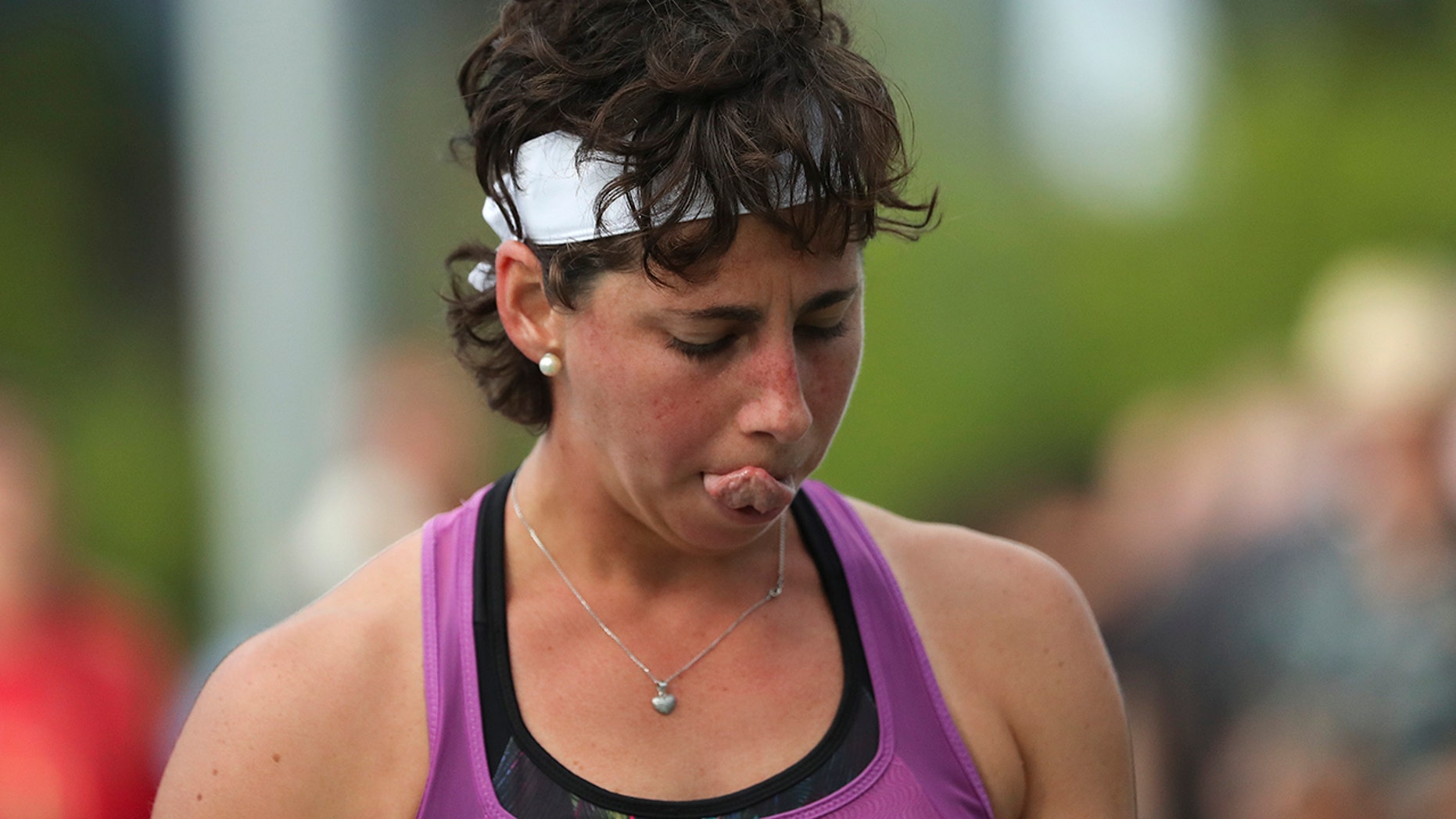Carla Suarez Navarro, of Spain, reacts after losing a point to Timea Babos, of Hungary, during the first round of the US Open tennis tournament Tuesday, Aug. 27, 2019, in New York. (AP Photo/Eduardo Munoz Alvarez)