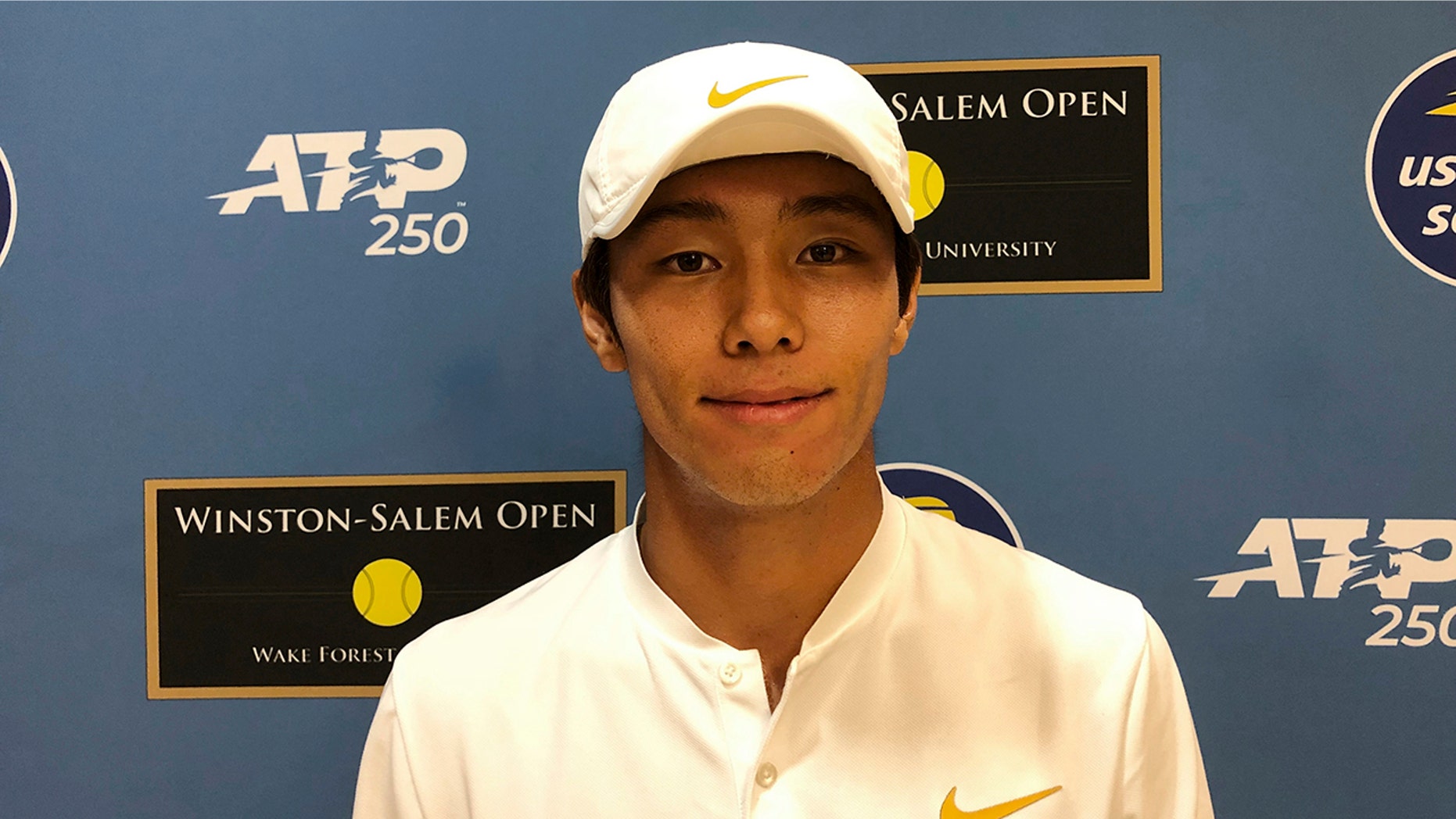 Tennis player Duckhee Lee, of South Korea, poses following his tennis match, Monday, Aug. 19, 2019, at the Winston-Salem Open in Winston-Salem, N.C. Lee became the first deaf professional to play in an ATP-level tennis tournament. (AP Photo/Joedy McCreary)