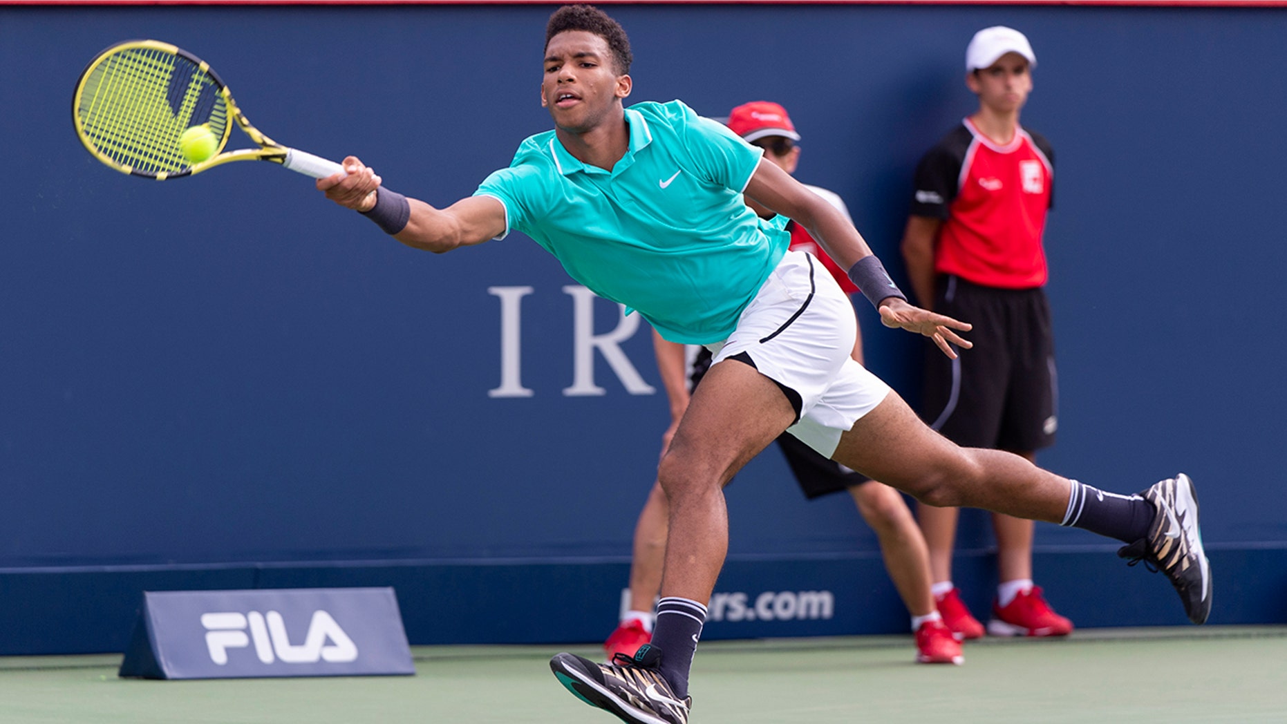 Felix Auger-Aliassime of Canada lunges to return to compatriot Vasek Pospisil during a first round match at the Rogers Cup tennis tournament in Montreal, Tuesday, Aug. 6, 2019. (Paul Chiasson/The Canadian Press via AP)