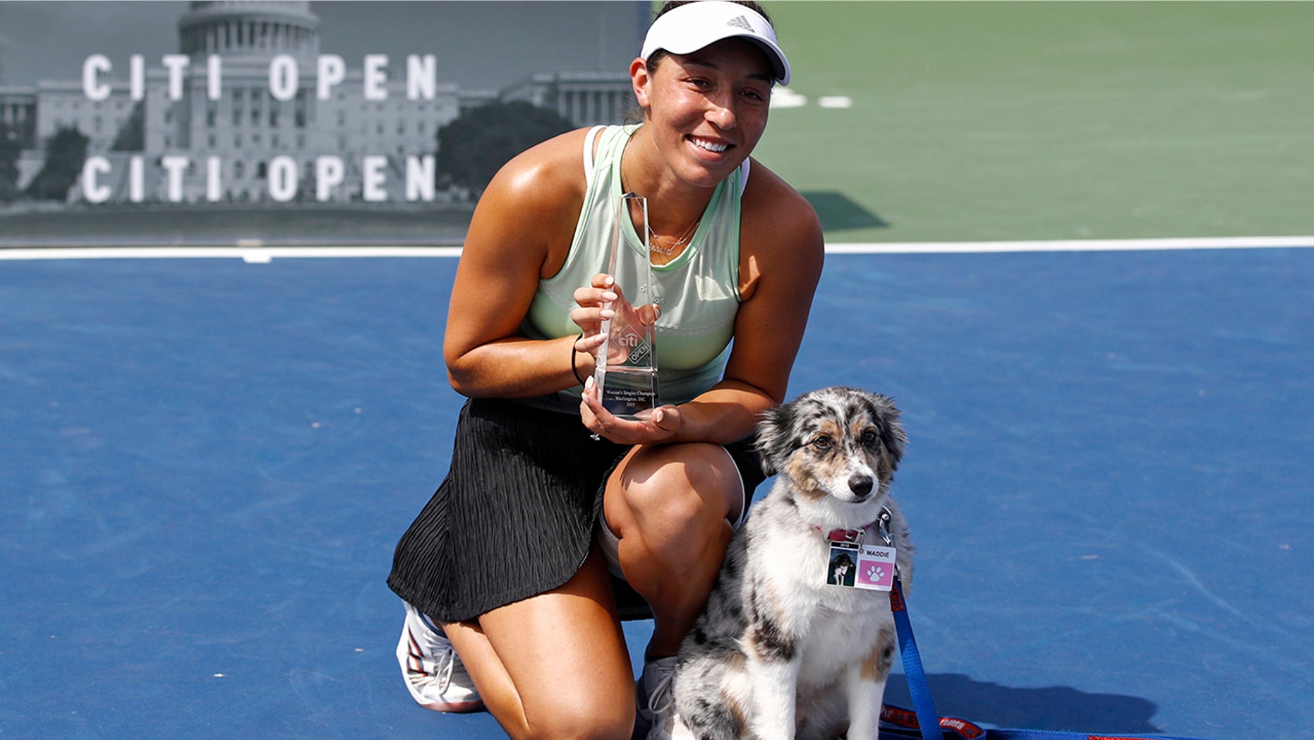 Jessica Pegula poses with a trophy and her dog Maddie after defeating Camila Giorgi, of Italy, in a final match at the Citi Open tennis tournament, Sunday, Aug. 4, 2019, in Washington. (AP Photo/Patrick Semansky)