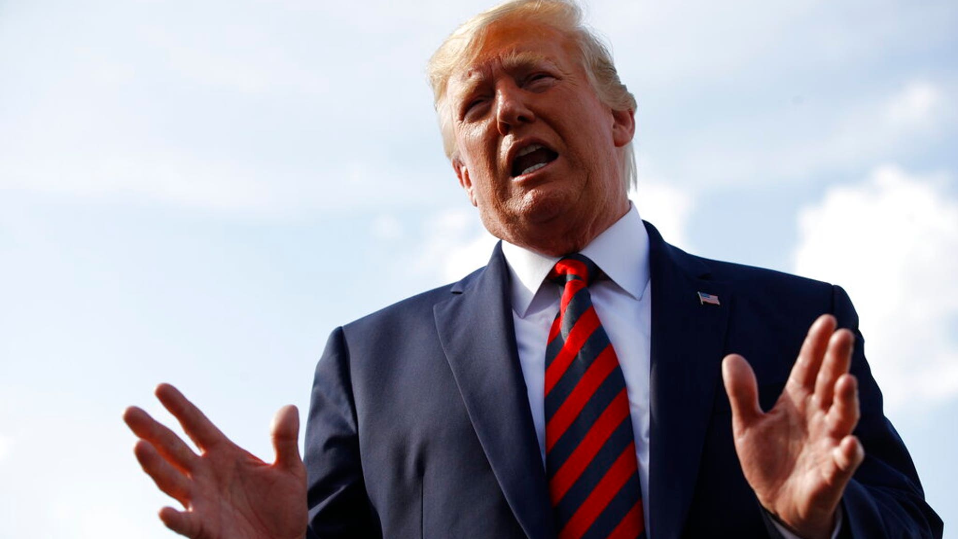 President Donald Trump speaks with reporters before boarding Air Force One with first lady Melania Trump at Morristown Municipal Airport in Morristown, N.J., Sunday, Aug. 18, 2019, en route to Andrews Air Force Base, Md. (AP Photo/Patrick Semansky)