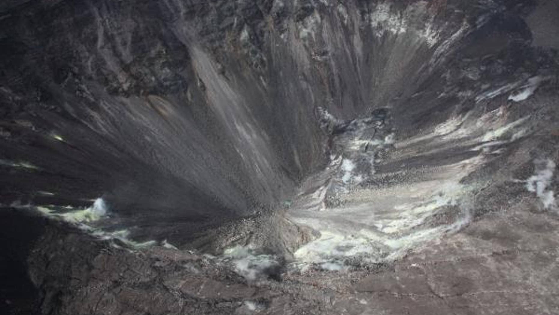 On Aug.1, scientists with the USGS Hawaiian Volcano Observatory snapped this photo of the Kilauea Volcano and the small, green patch of water at the bottom of its crater.