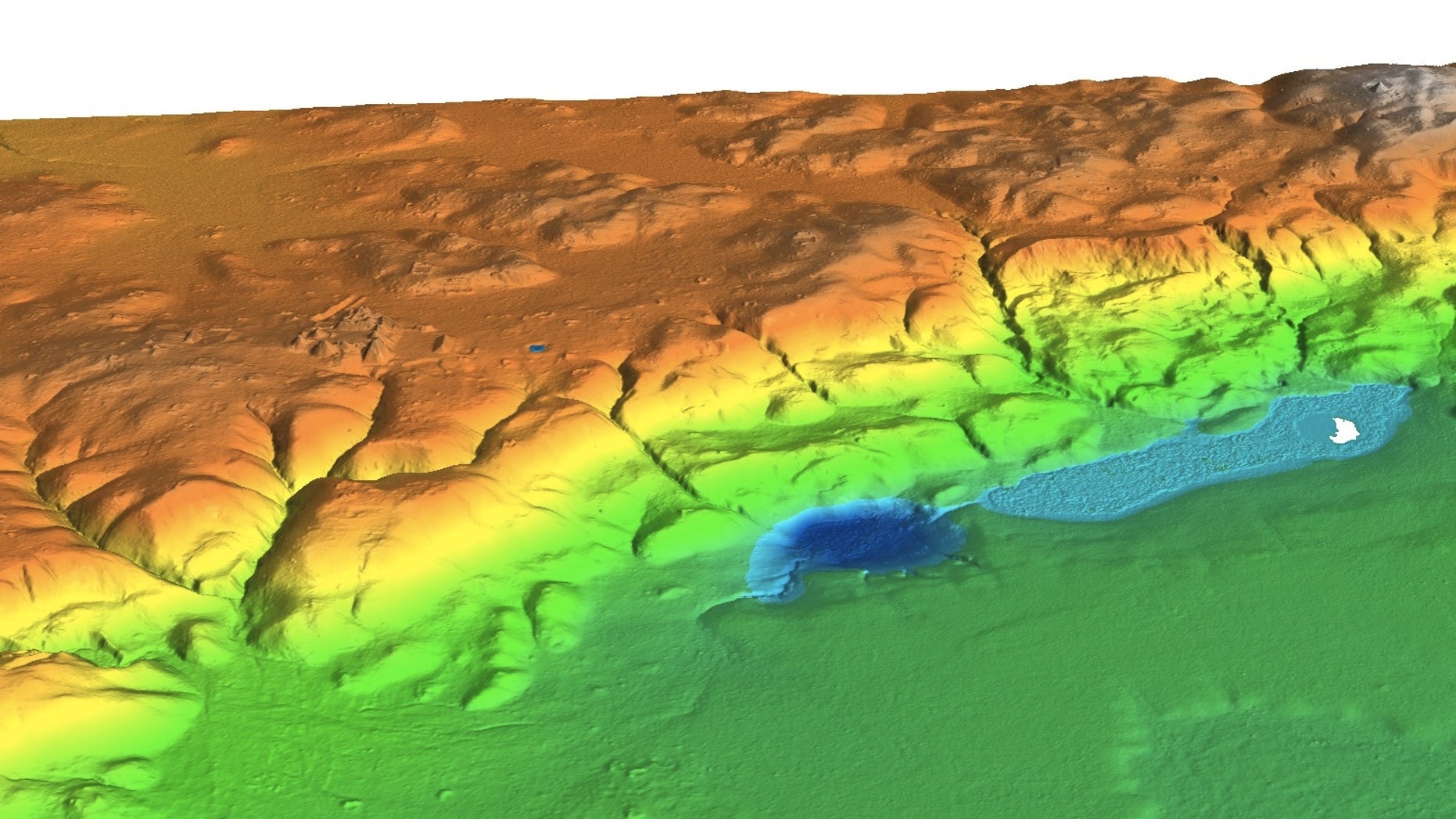 A lidar survey shows the entire ceremonial center stretching for 1.2 miles (2 kilometers) along a limestone ridge overlooking Laguna Ek'Naab (white spot), the sampling site for the paleoenvironmental study on the Maya.