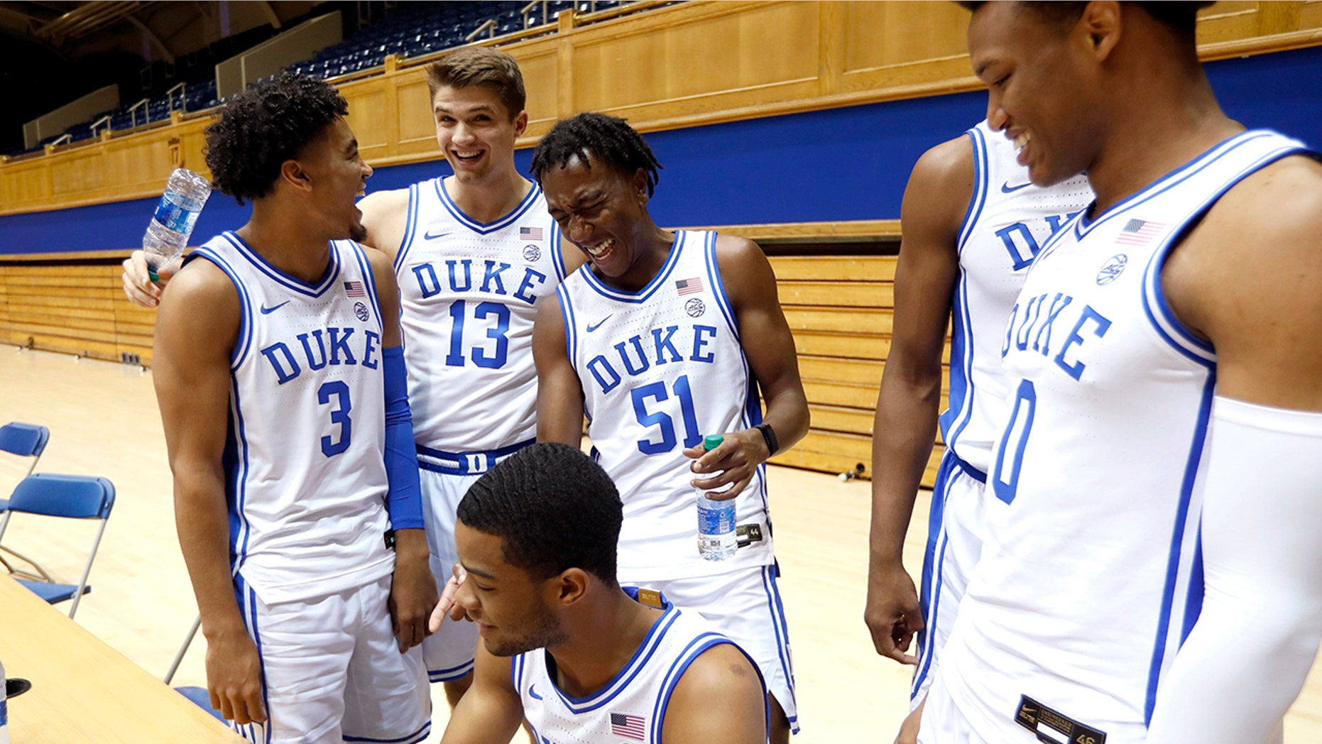 Duke's Tre Jones (3) laughs with Joey Baker (13), Mike Buckmire (51), Cassius Stanley (2), bottom left, and Wendell Moore (0) during an NCAA college basketball media day at Cameron Indoor Stadium in Durham, N.C., Monday, Sept. 23, 2019. (Ethan Hyman/The News & Observer via AP)