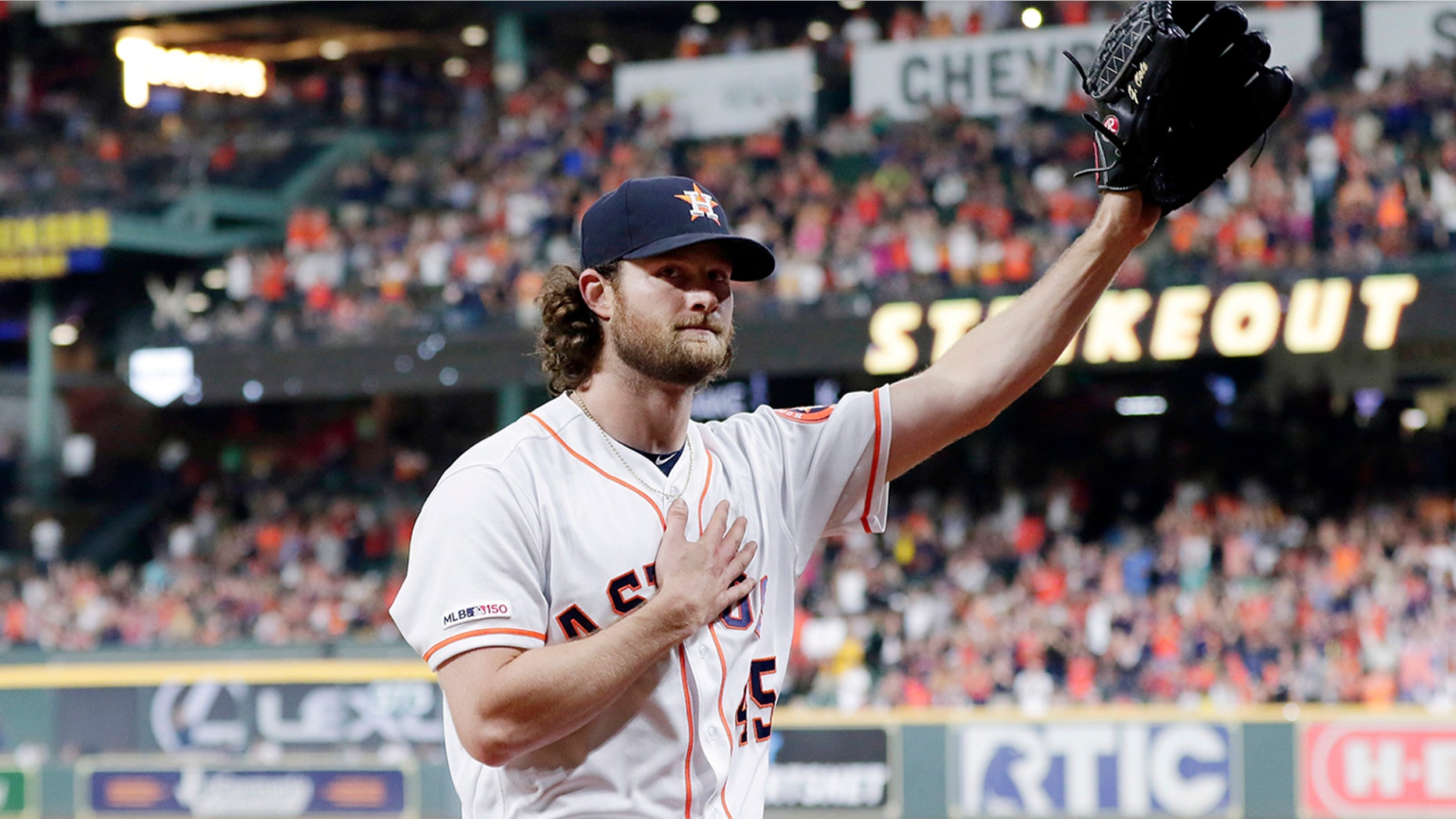 Houston Astros starting pitcher Gerrit Cole waves to the crowd as he leaves the mound after striking out Texas Rangers designated hitter Shin-Soo Choo for his 300th season strikeout during the sixth inning of a baseball game Wednesday, Sept. 18, 2019, in Houston. (AP Photo/Michael Wyke)