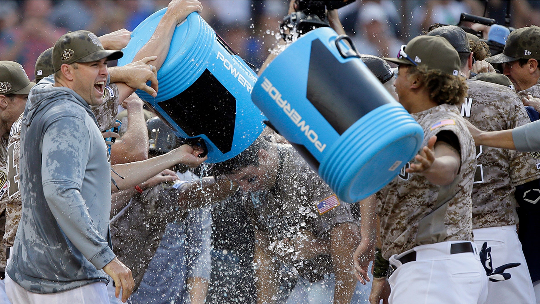 San Diego Padres' Seth Mejias-Brean, center, is doused in a celebration with teammates after hitting a walkoff two-run home run against the Arizona Diamondbacks during the 10th inning of a baseball game in San Diego, Sunday, Sept. 22, 2019. (AP Photo/Alex Gallardo)
