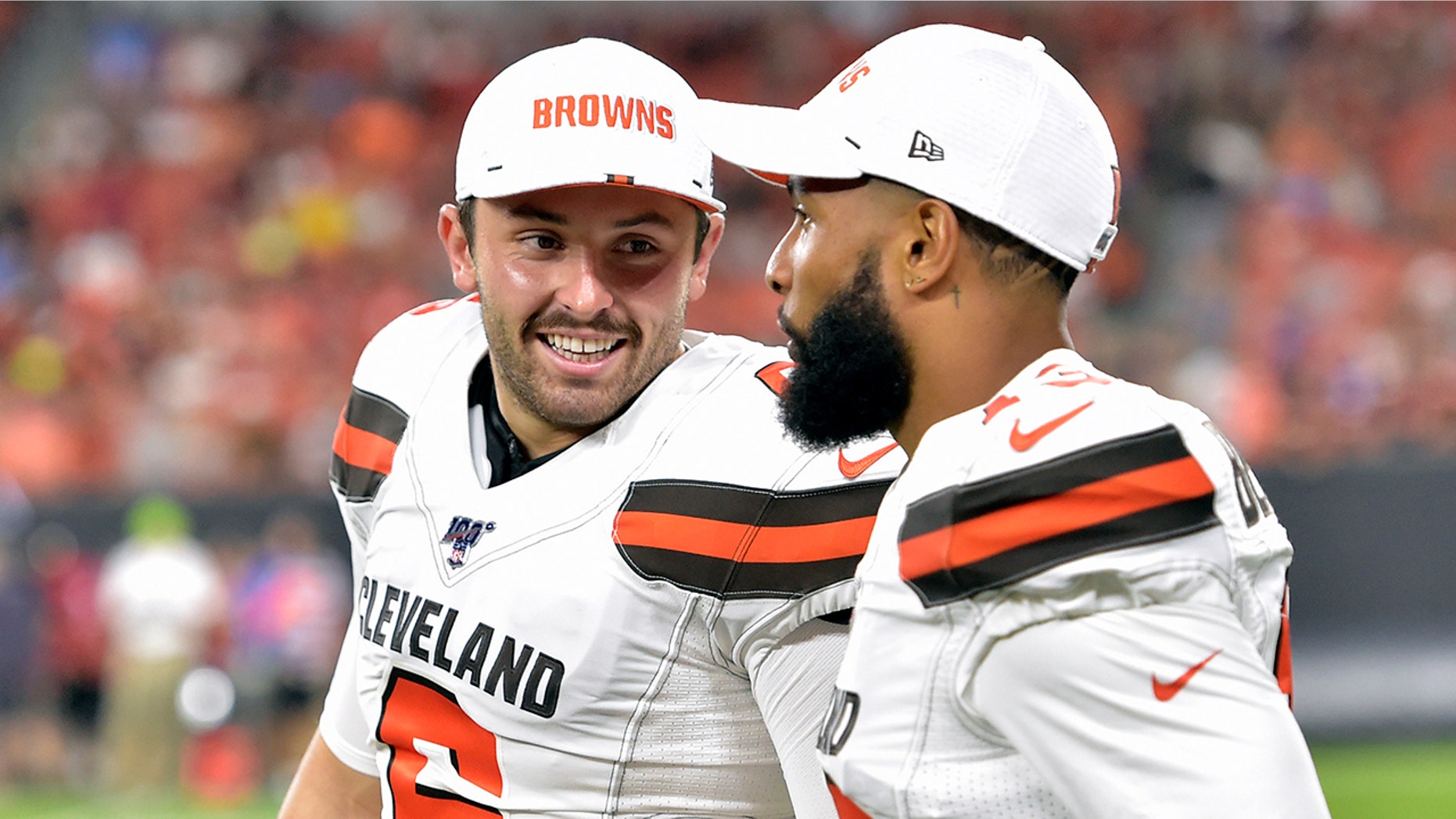FILE - In this Aug. 8, 2019, file photo, Cleveland Browns' Baker Mayfield, left, smiles as he talks with wide receiver Odell Beckham Jr. during the second half of an NFL preseason football game against the Washington Redskins in Cleveland. Mayfield isn’t concerned about the huge expectations being placed on the Browns, who went 7-8-1 during his rookie season but upgraded their roster and should compete for their first playoff spot since 2002. (AP Photo/David Richard, File)
