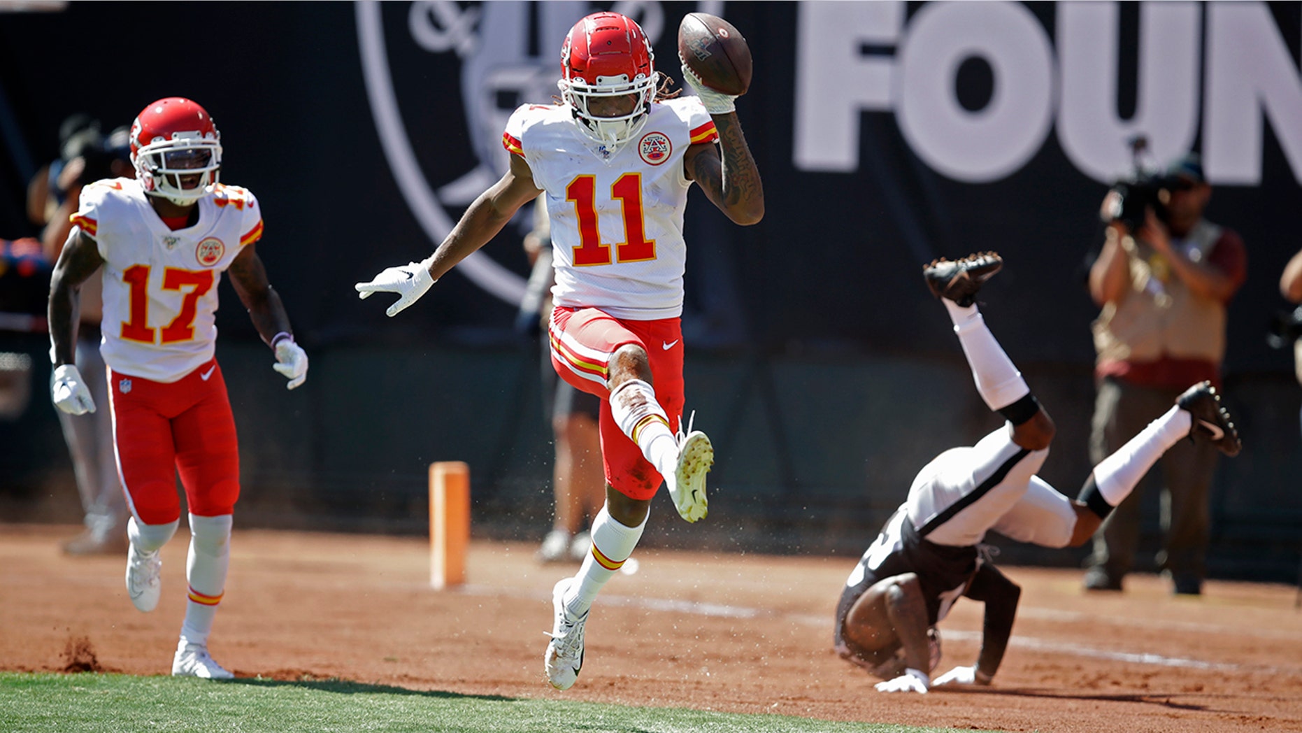 Kansas City Chiefs wide receiver Demarcus Robinson (11) celebrates after scoring a touchdown as teammate Mecole Hardman (17) looks on during the first half of an NFL football game against the Oakland Raiders Sunday, Sept. 15, 2019, in Oakland, Calif. At right is Oakland Raiders cornerback Gareon Conley. (AP Photo/Ben Margot)