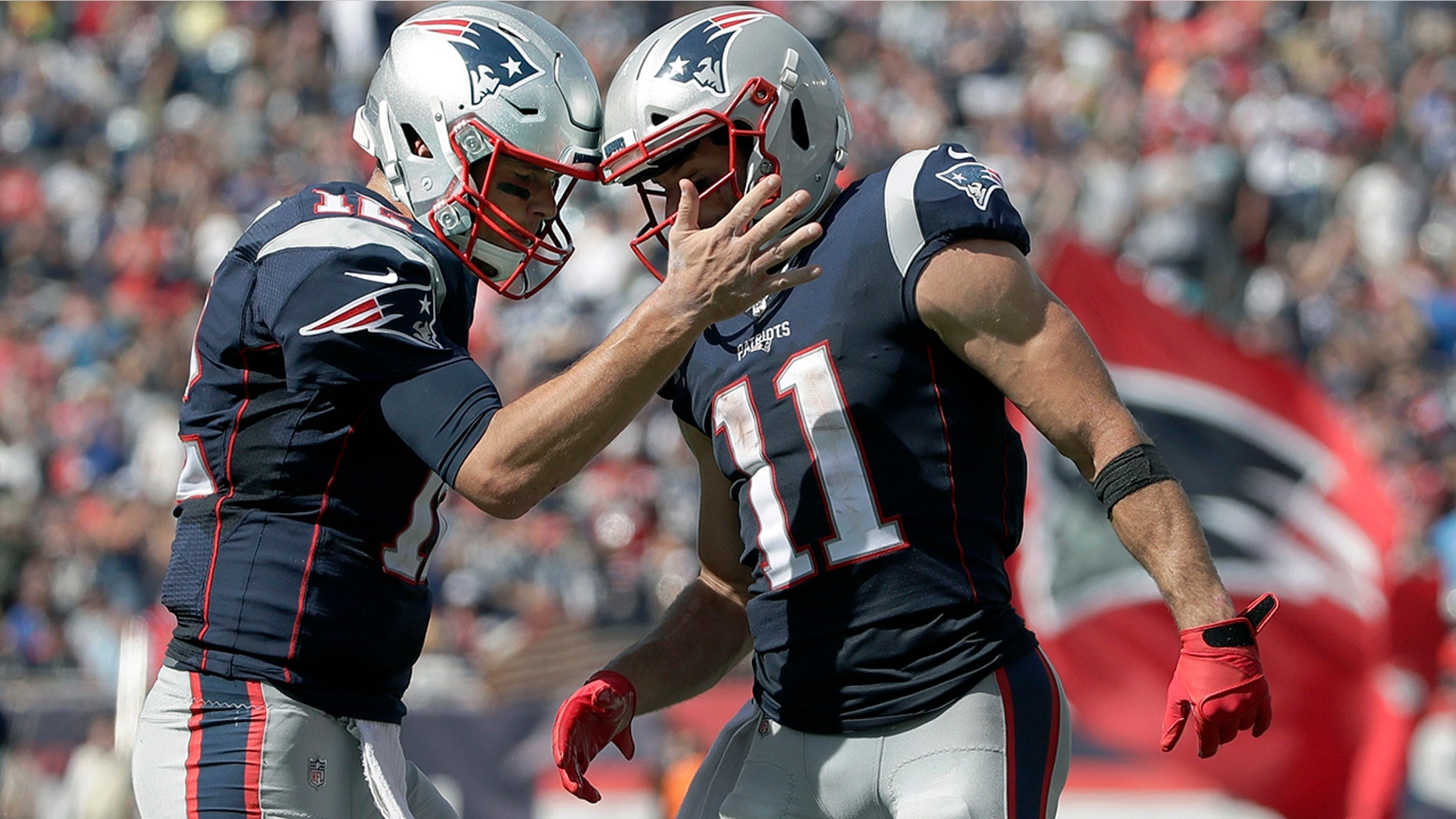 New England Patriots quarterback Tom Brady, left, celebrates his touchdown pass to Julian Edelman, right, in the first half of an NFL football game against the New York Jets, Sunday, Sept. 22, 2019, in Foxborough, Mass. (AP Photo/Elise Amendola)
