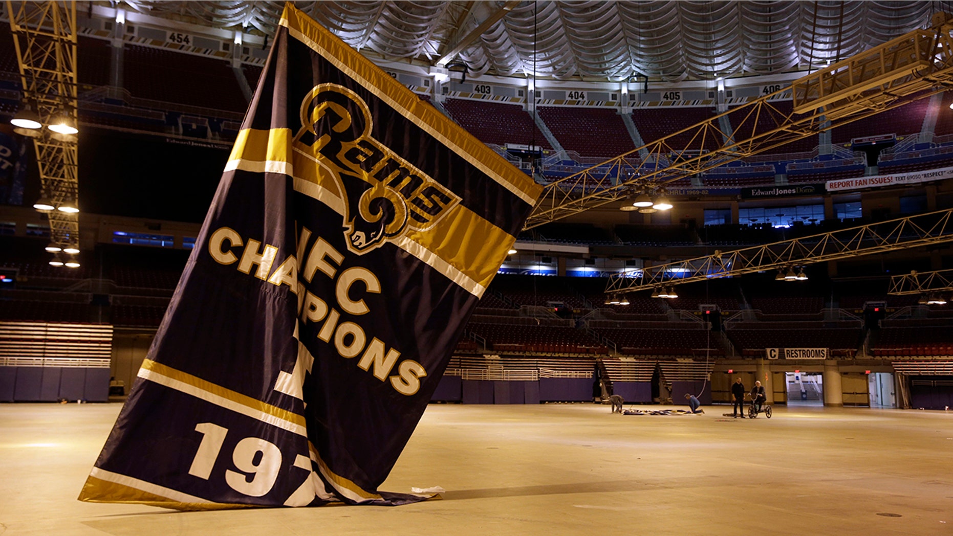 FILE - In this Jan. 14, 2016, file photo, championship banners are removed from the Edward Jones Dome, former home of the St. Louis Rams football team, in St. Louis. (AP Photo/Jeff Roberson, File)
