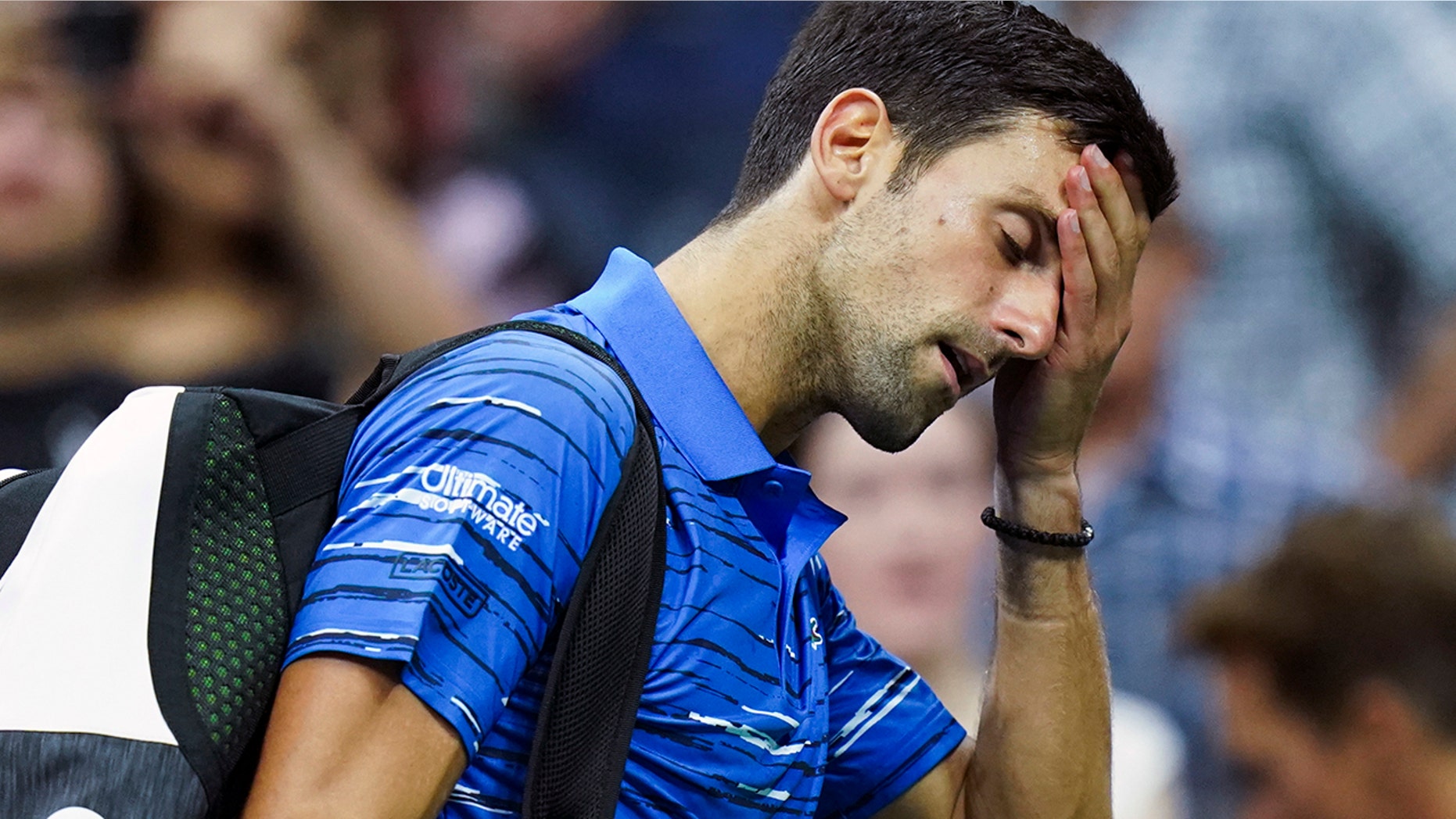 Novak Djokovic, of Serbia, walks off the court as he retires during his match against Stan Wawrinka, of Switzerland, during the fourth round of the U.S. Open tennis championships, Sunday, Sept. 1, 2019, in New York. (AP Photo/Eduardo Munoz Alvarez)