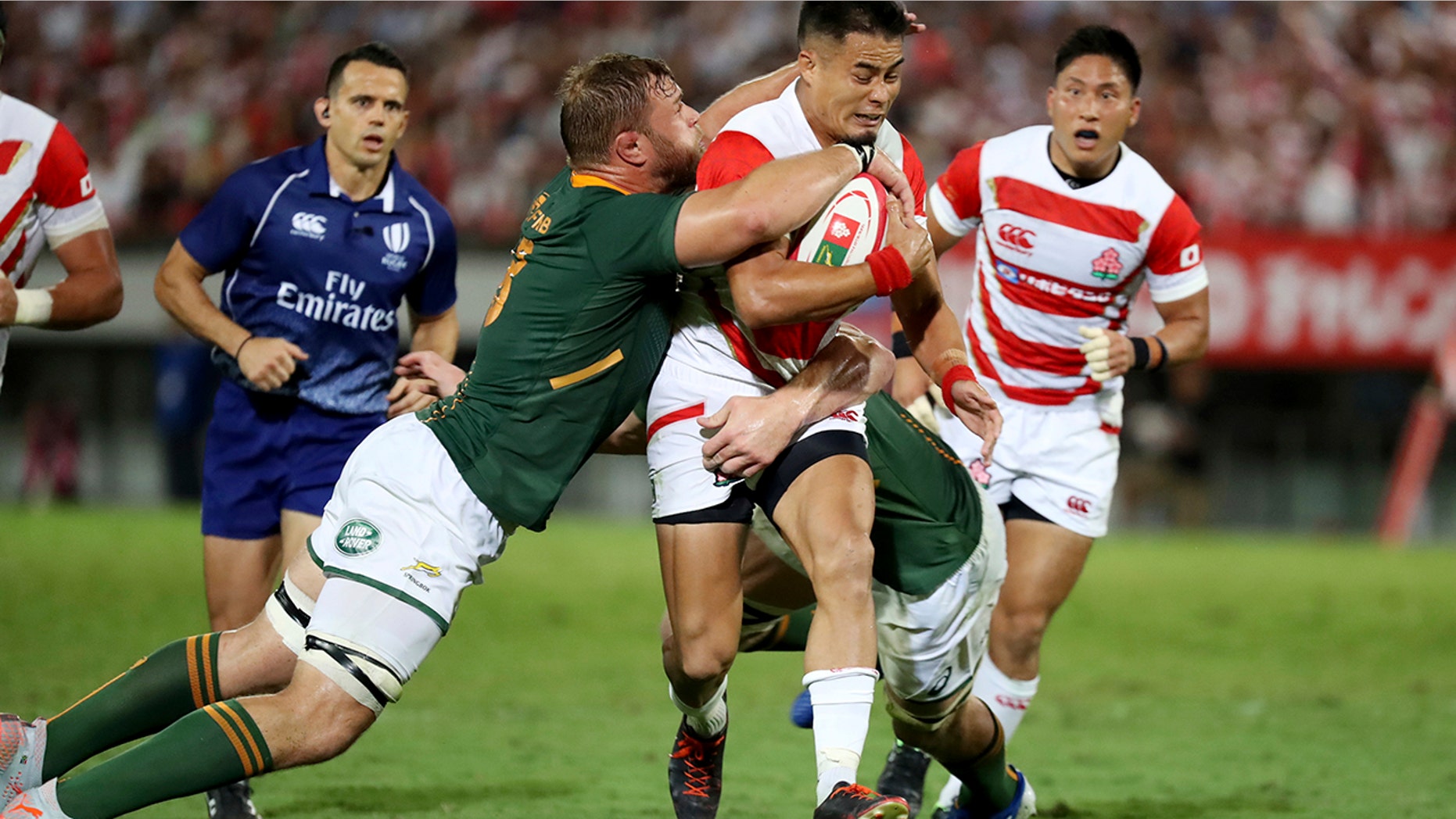 Japan's Yu Tamura (10) runs against South Africa's Duane Vermeulen (8) during a rugby match at Kumagaya Rugby Stadium Friday, Sept. 6, 2019, in Saitama, Japan. (AP Photo/Eugene Hoshiko)
