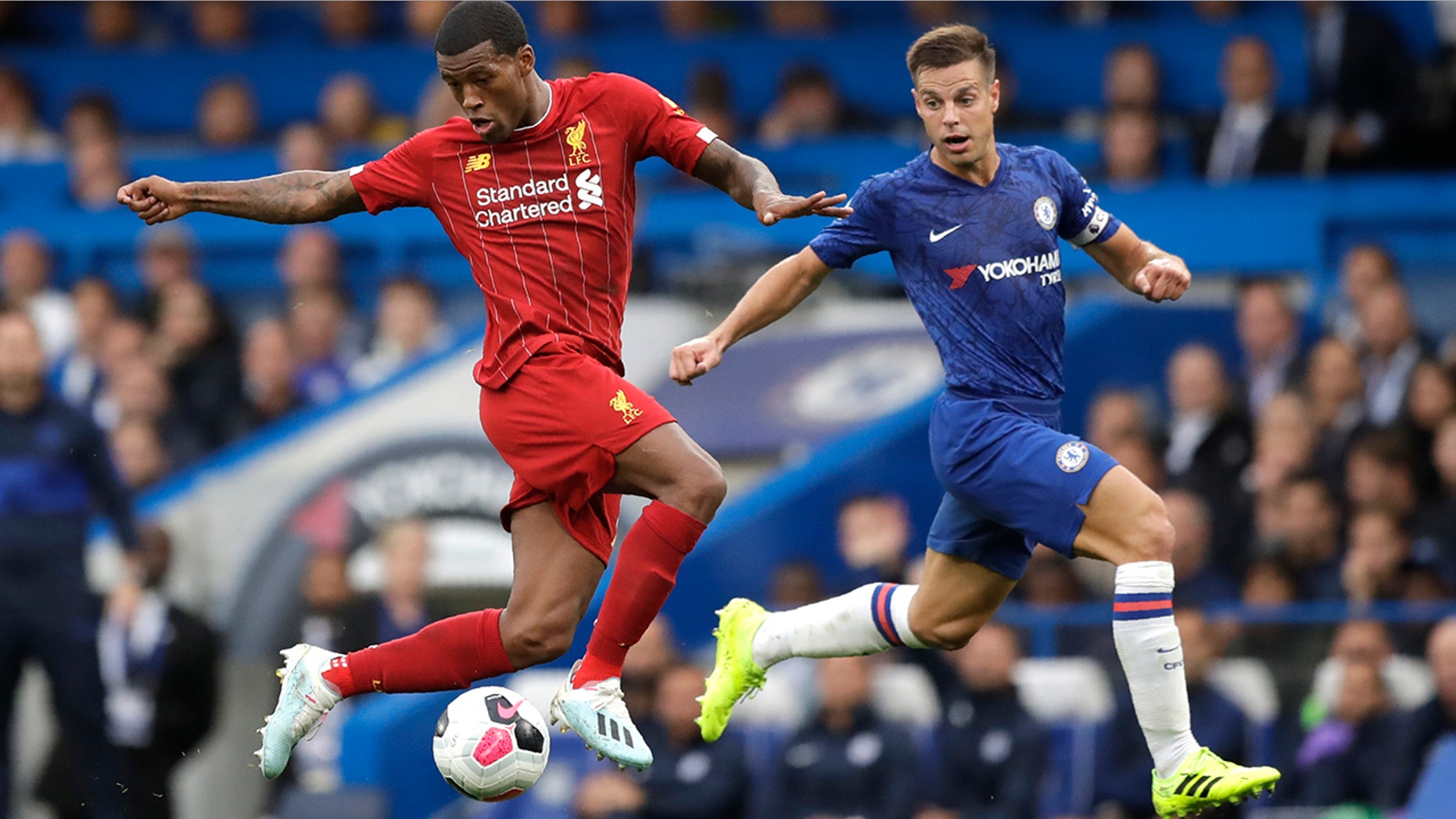 Liverpool's Georginio Wijnaldum, left, and Chelsea's Cesar Azpilicueta compete for the ball during the British premier League soccer match between Chelsea and Liverpool, at the Stamford Bridge Stadium, London, Sunday, Sept. 22, 2019. (AP Photo/Matt Dunham)