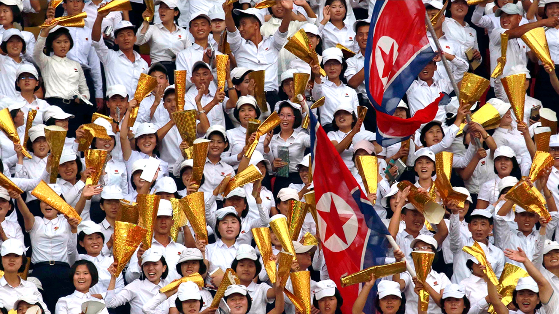 North Korea's fans celebrate during the World Cup Group H qualifying soccer match between North Korea and Lebanon at the Kim Il Sung Stadium in Pyongyang, Thursday, Sept. 5, 2019. North Korea won the game 2-0. (AP Photo/Jon Chol Jin)