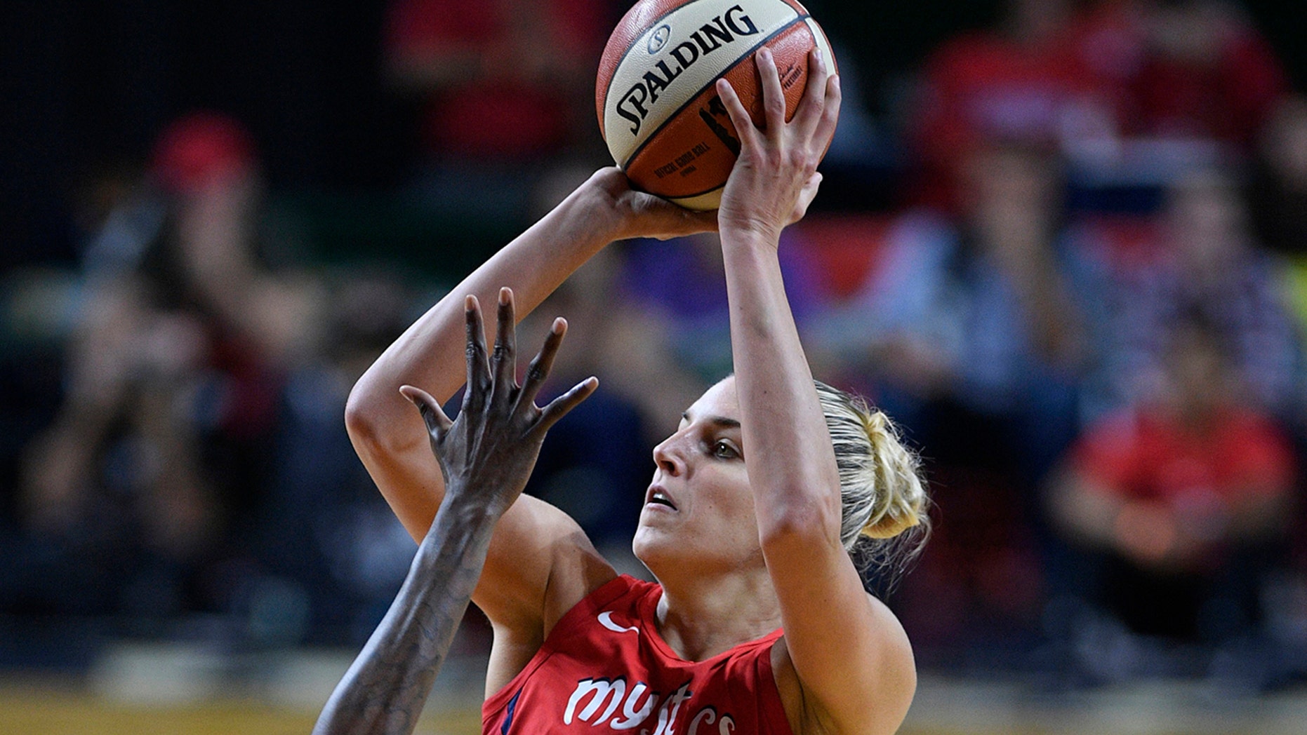FILE - In this Sept. 12, 2018, file photo, Washington Mystics forward Elena Delle Donne (11) shoots against the Seattle Storm during the second half of Game 3 of the WNBA basketball finals, in Fairfax, Va. Delle Donne was named the Associated Press WNBA OPlayer of the Year, Wednesday, Sept. 11, 2019. (AP Photo/Nick Wass, File)