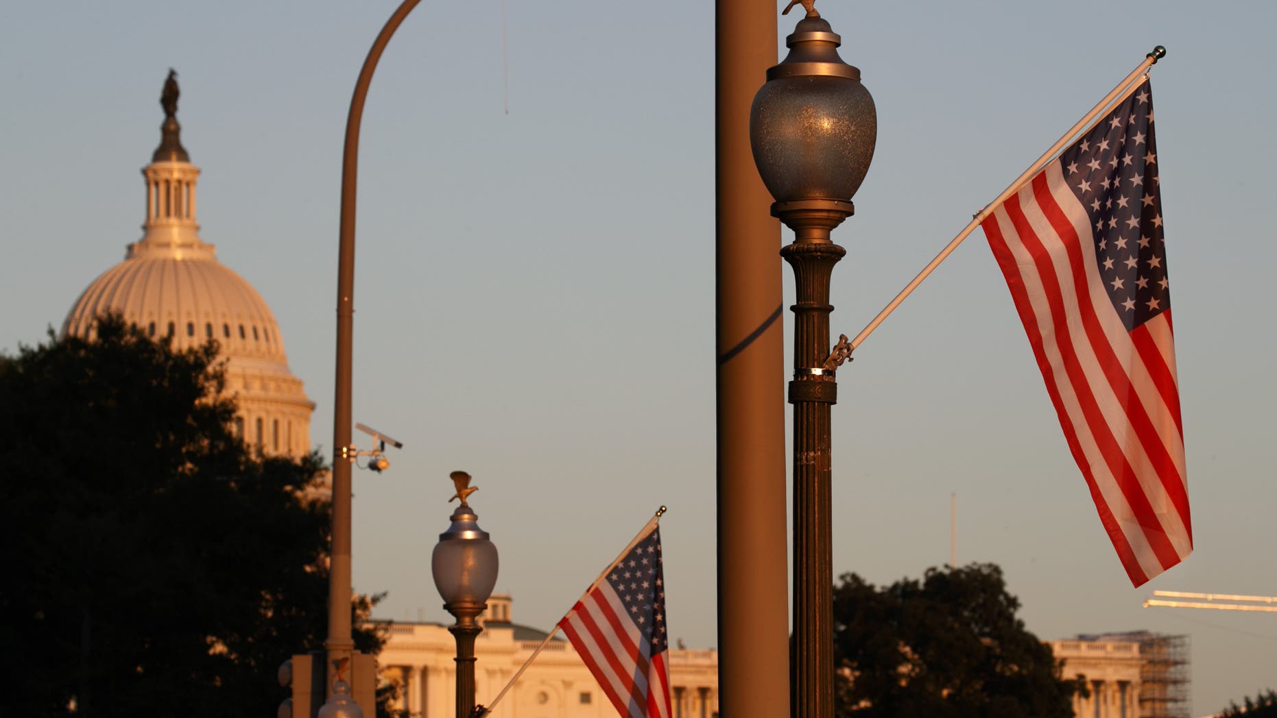 Flags fly at sunset with 51 instead of the usual 50 stars, along Pennsylvania Ave., part of a display in support of statehood for the District of Columbia, Sunday, Sept. 15, 2019, in Washington. (AP Photo/Jacquelyn Martin)