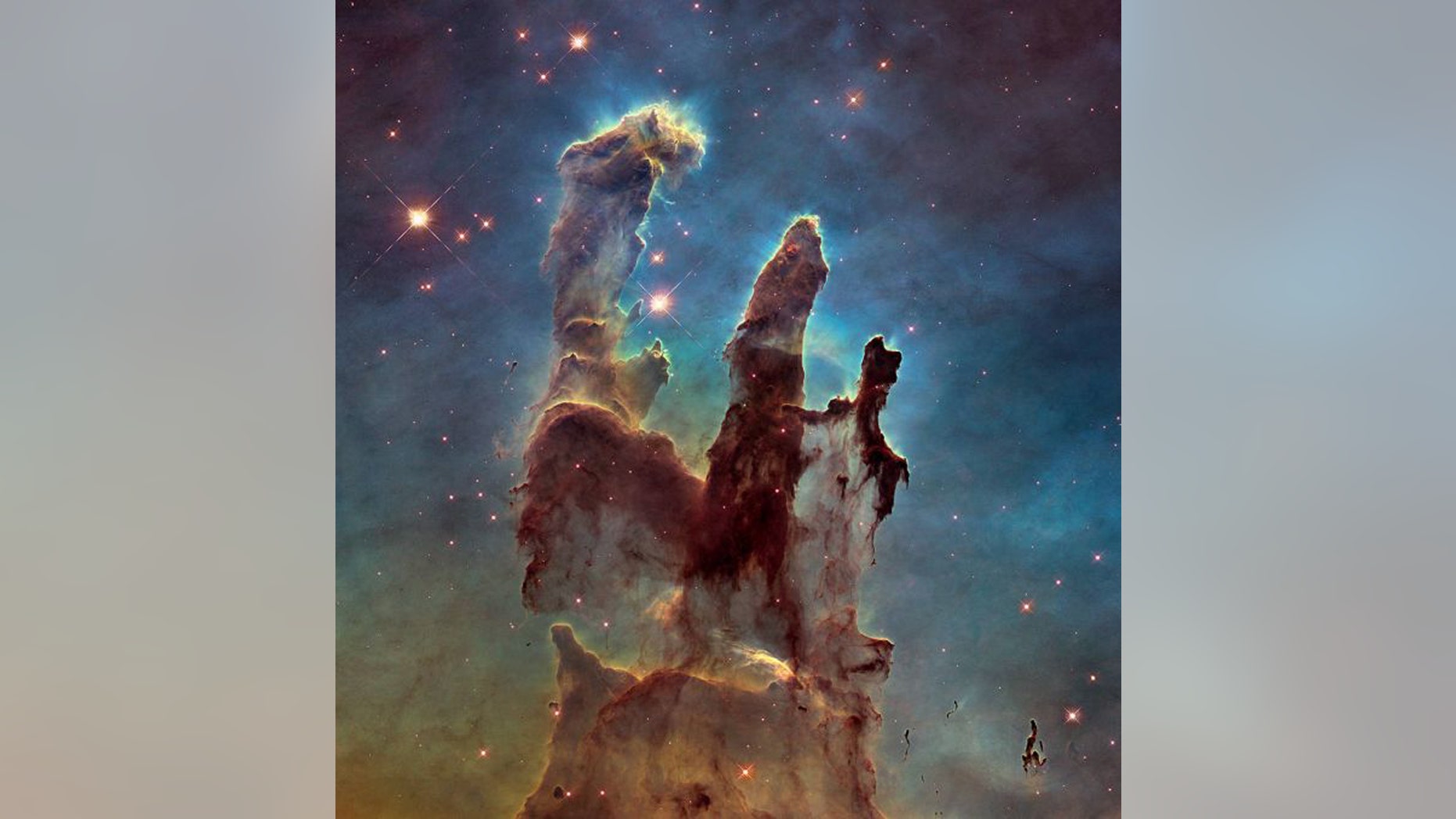 The Pillars of Creation are towering formations of cosmic gas and dust that lie in the center of the Eagle Nebula. A research team in Japan just discovered towering Giant Elephant Trunks that are much larger than these pillars. (Credit: NASA, ESA and the Hubble Heritage Team (STScI/AURA))