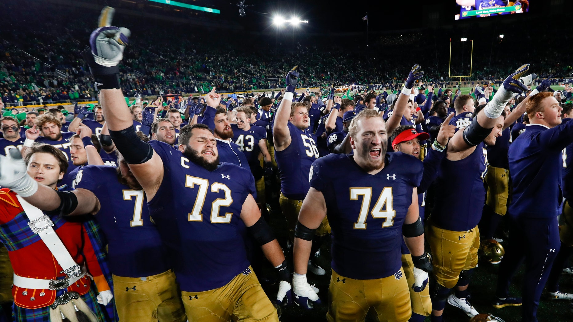 Notre Dame offensive linemen Robert Hainsey (72) and Liam Eichenberg (74) celebrate after defeating Southern California in an NCAA college football game in South Bend, Ind., Saturday, Oct. 12, 2019. (AP Photo/Paul Sancya)