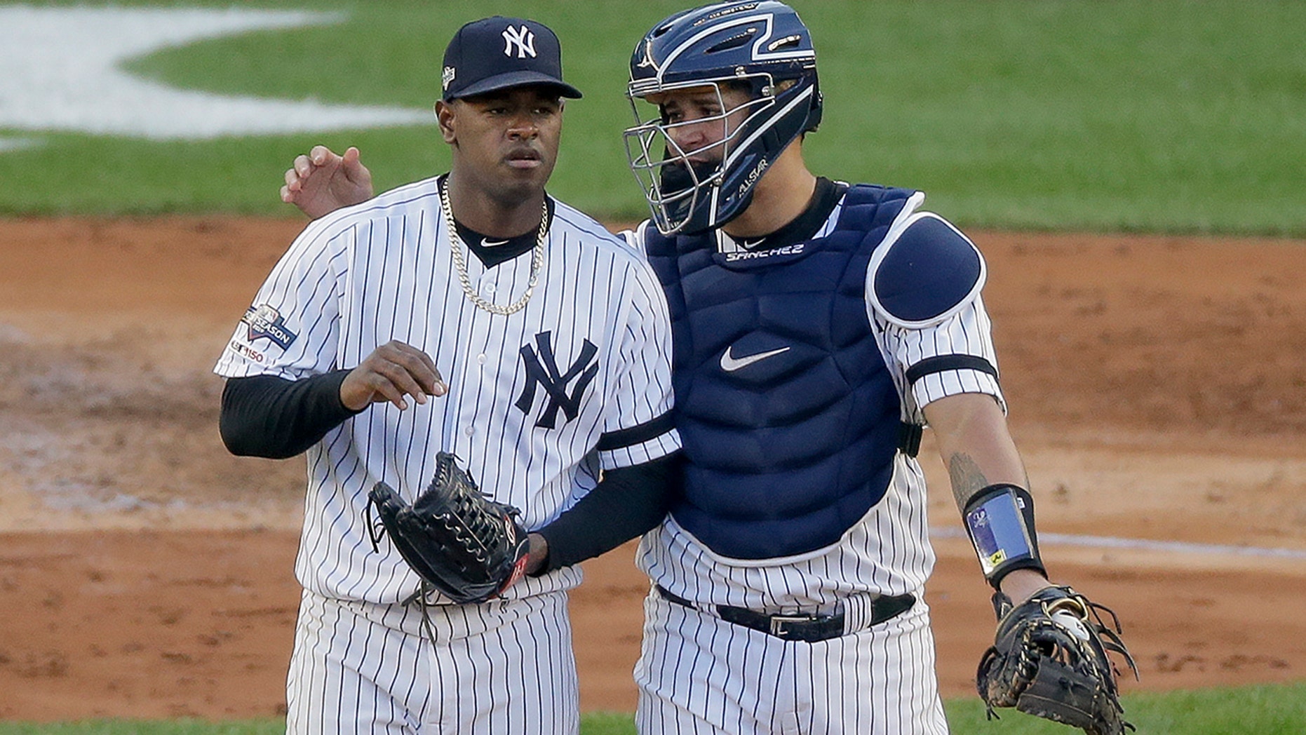New York Yankees catcher Gary Sanchez talks on the mound with starting pitcher Luis Severino (40) during the fourth inning of Game 3 of baseball's American League Championship Series against the Houston Astros, Tuesday, Oct. 15, 2019, in New York. (AP Photo/Seth Wenig)