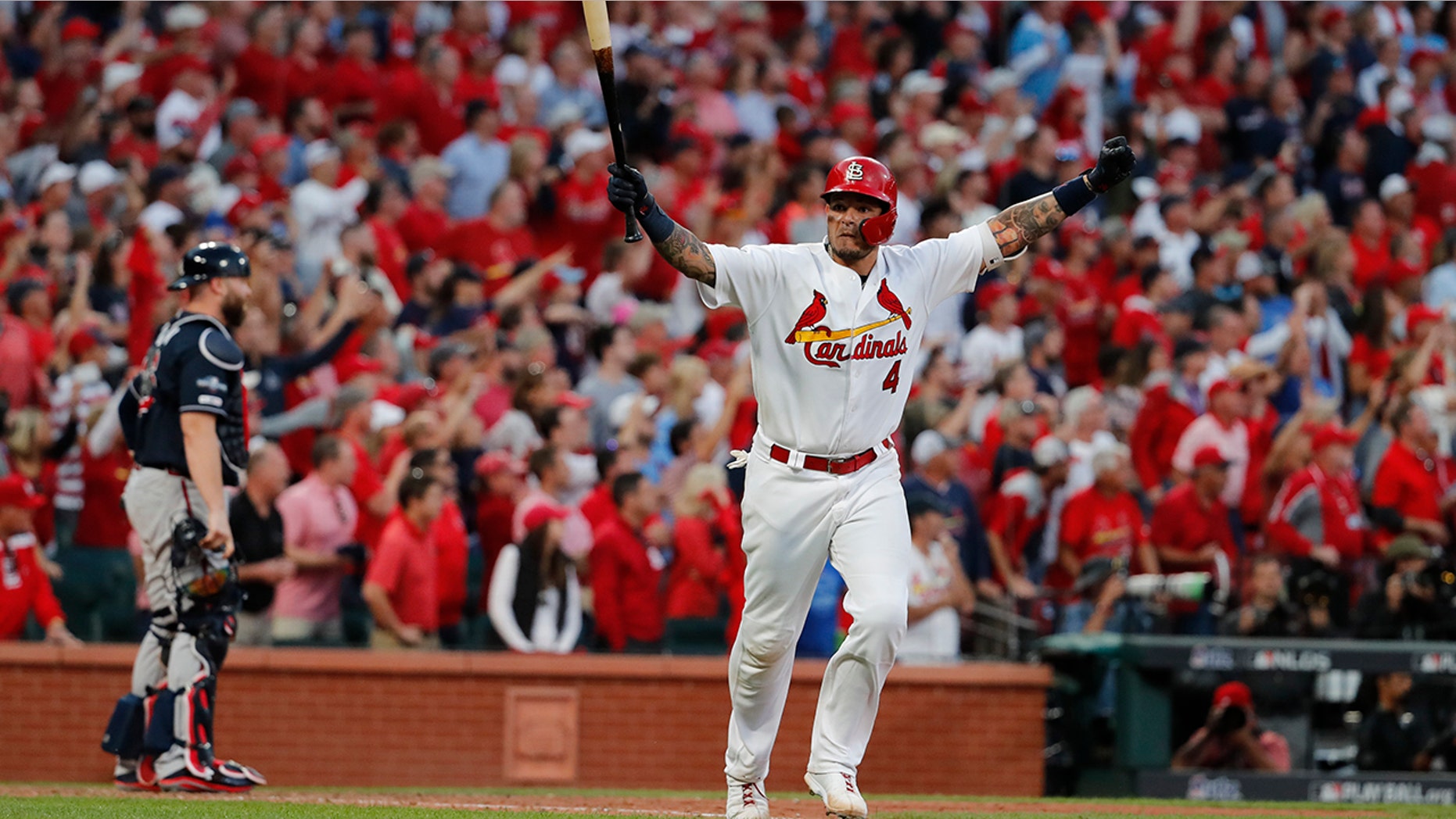 St. Louis Cardinals' Yadier Molina celebrates after hitting a sacrifice fly to score Kolten Wong and defeat the Atlanta Braves in Game 4 of a baseball National League Division Series, Monday, Oct. 7, 2019, in St. Louis. The Cardinals won 5-4. (AP Photo/Jeff Roberson)