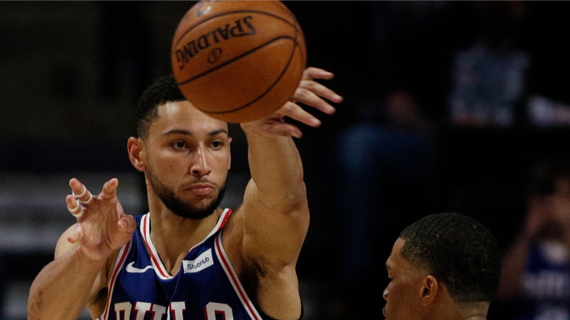 Philadelphia 76ers guard Ben Simmons, left, passes around Charlotte Hornets forward Miles Bridges in the second half of a preseason NBA basketball game in Winston-Salem, N.C., Friday, Oct. 11, 2019. (AP Photo/Nell Redmond)
