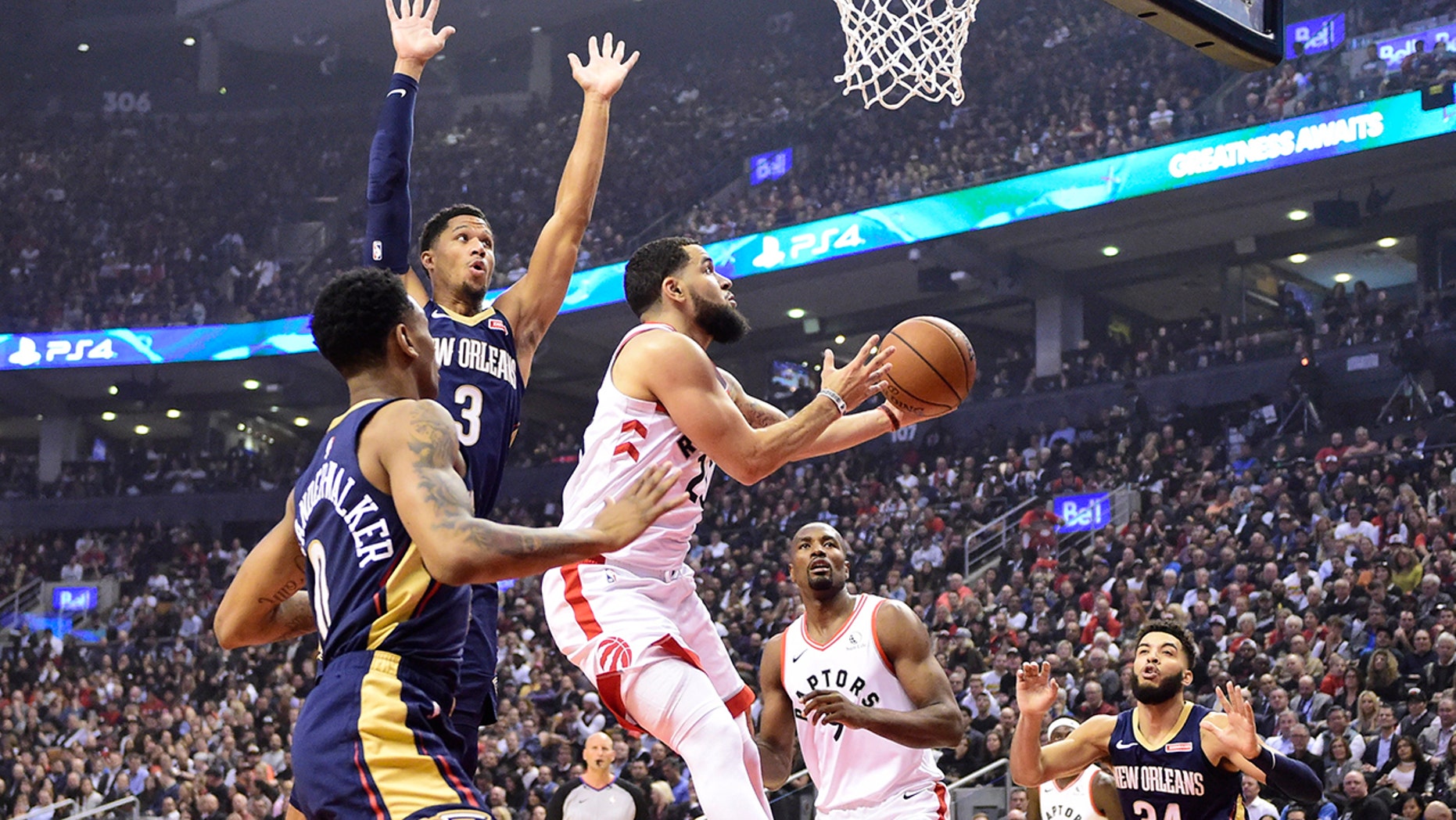 Toronto Raptors guard Fred VanVleet (23) goes to the basket as New Orleans Pelicans' Josh Hart (3) and Nickeil Alexander-Walker (0) defend during the first half of an NBA basketball game Tuesday, Oct. 22, 2019, in Toronto. (Frank Gunn/The Canadian Press via AP)