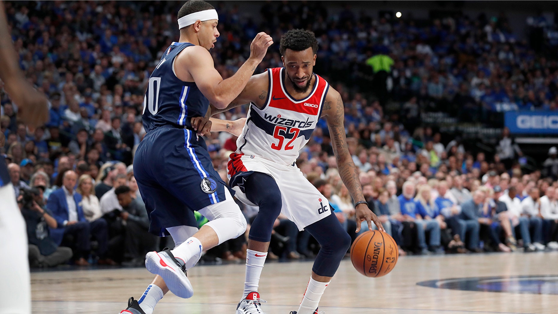 Washington Wizards' Jordan McRae (52) drives to the basket as Dallas Mavericks' Seth Curry defends during the second quarter of an NBA basketball game in Dallas, Wednesday, Oct. 23, 2019. (AP Photo/Tony Gutierrez)