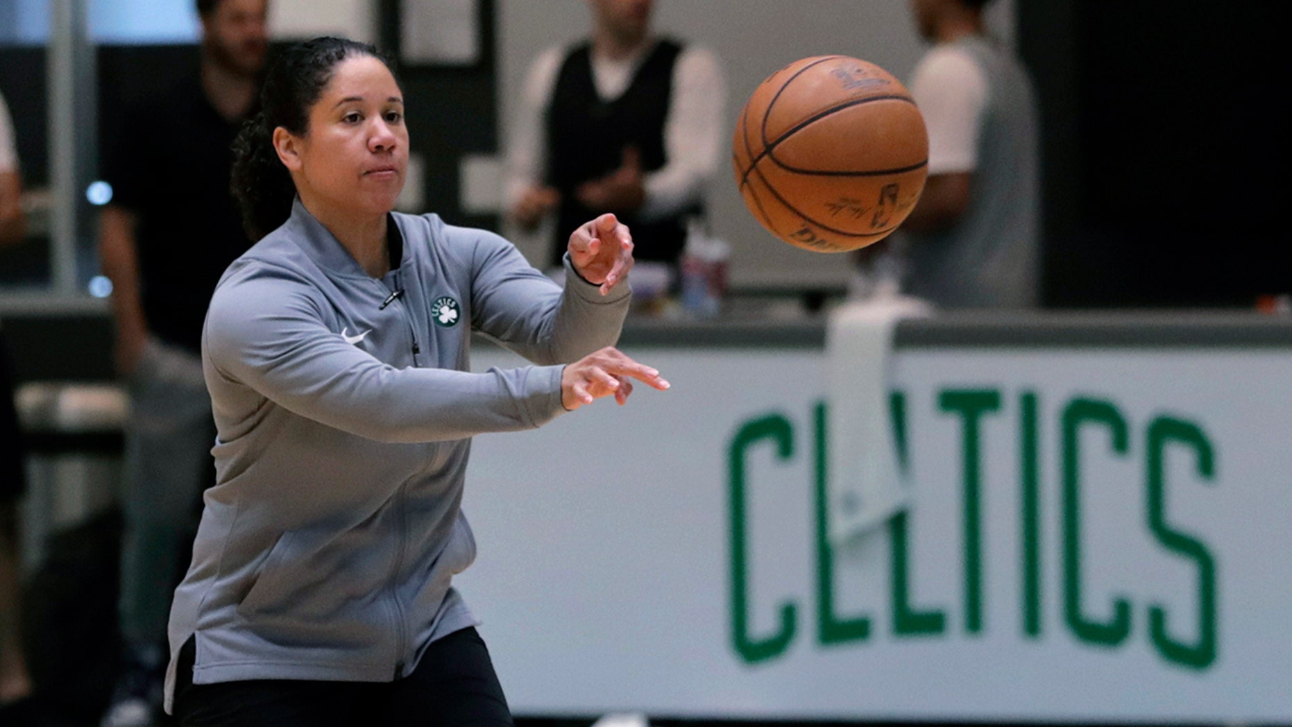 FILE - In this July 1, 2019, file photo, Boston Celtics assistant coach Kara Lawson passes the ball at the team's training facility in Boston. Celtics guard Gordon Hayward said Lawson has already made her presence felt. “She’s been good as far as just the experience she has as a basketball player,” Hayward said. “Reading the game and kind of little things she sees coaching on the sideline. Having somebody that well-versed in basketball, that experience is good.” (AP Photo/Charles Krupa, File)