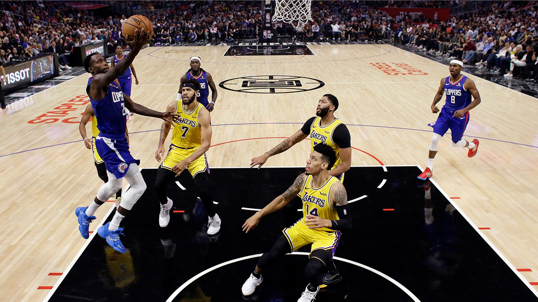 Los Angeles Clippers' Patrick Beverley, left, drives to the basket against the Los Angeles Lakers during the first half of an NBA basketball game Tuesday, Oct. 22, 2019, in Los Angeles. (AP Photo/Marcio Jose Sanchez)