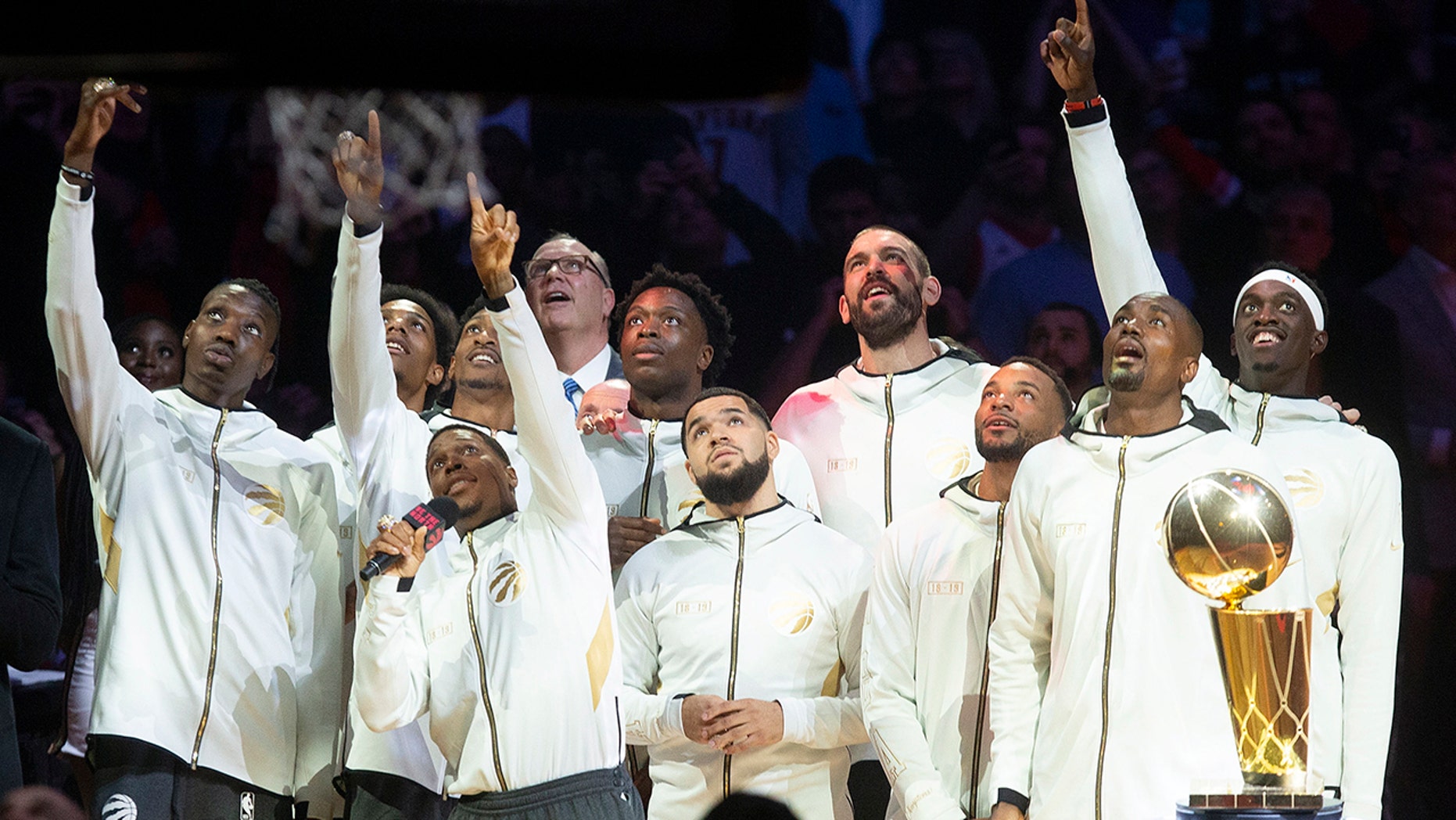 Toronto Raptors watch their 2019 NBA basketball championship pennant being raised before the team's game against the New Orleans Pelican on Tuesday, Oct. 22, 2019, in Toronto. (Chris Young/The Canadian Press via AP)