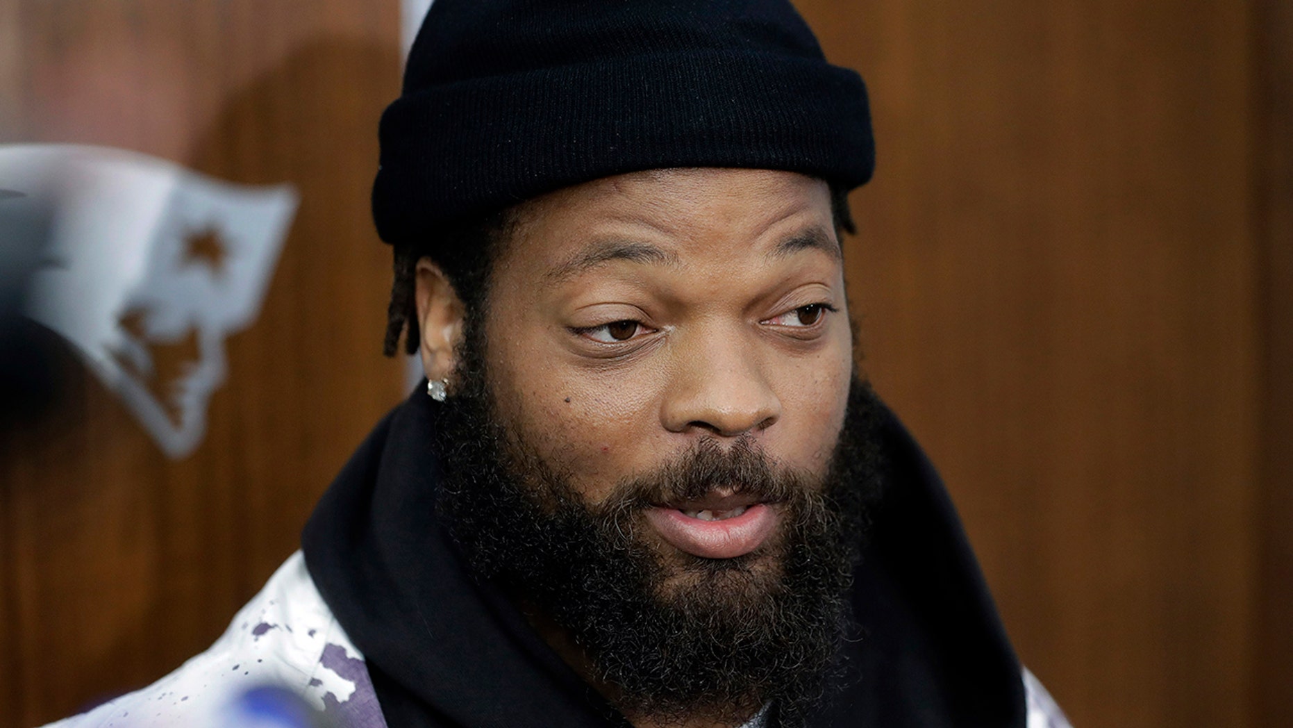 New England Patriots defensive lineman Michael Bennett speaks with members of the media in the team's locker room following NFL football practice, Wednesday, Oct. 23, 2019, in Foxborough, Mass. (AP Photo/Steven Senne)
