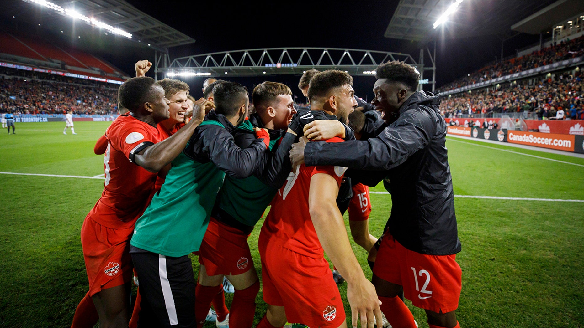 Canada midfielder Alphonso Davies (12) looks at forward Lucas Cavallini as they celebrate Cavallini's goal against the United States during the second half of a CONCACAF Nations League soccer match Tuesday, Oct. 15, 2019, in Toronto. (Cole Burston/The Canadian Press via AP)